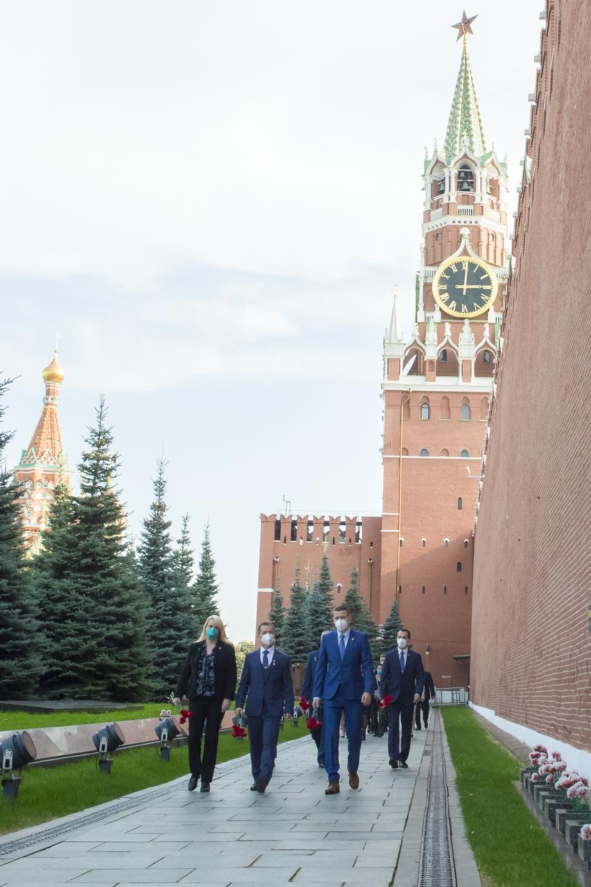 Expedition 64 prime crew members, NASA astronaut Kate Rubins, left, Russian cosmonaut Sergey Ryzhikov of Roscosmos, center, and Russian cosmonaut Sergey Kud-Sverchkov of Roscosmos visit Red Square to lay flowers at the site where Russian space icons are interred as part of traditional pre-launch ceremonies, Thursday, Sept. 24, 2020 in Moscow. Photo Credit: (NASA/GCTC/Irina Spector)