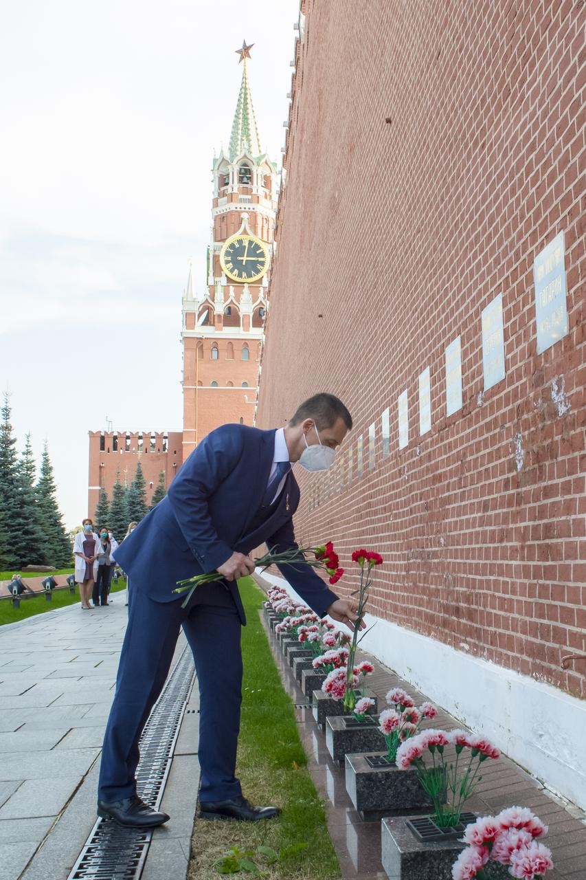 Expedition 64 prime crew member Sergey Ryzhikov of Roscosmos lays flowers at the site where Russian space icons are interred as part of traditional pre-launch ceremonies, Thursday, Sept. 24, 2020 in Moscow. Photo Credit: (NASA/GCTC/Irina Spector)