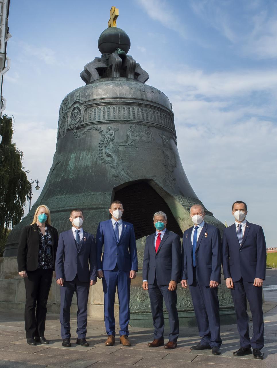 From left to right, Expedition 64 prime crew members, NASA astronaut Kate Rubins, Russian cosmonaut Sergey Ryzhikov of Roscosmos, Russian cosmonaut Sergey Kud-Sverchkov of Roscosmos and Expedition 64 backup crew members, NASA astronaut Mark Vande Hei, Russian cosmonaut Oleg Novitskiy of Roscosmos, and Russian cosmonaut Petr Dubrov of Roscosmos, pose for a photo in front of the Tsar Bell in Red Square after laying flowers at the site where Russian space icons are interred as part of traditional pre-launch ceremonies, Thursday, Sept. 24, 2020 in Moscow. Photo Credit: (NASA/GCTC/Irina Spector)