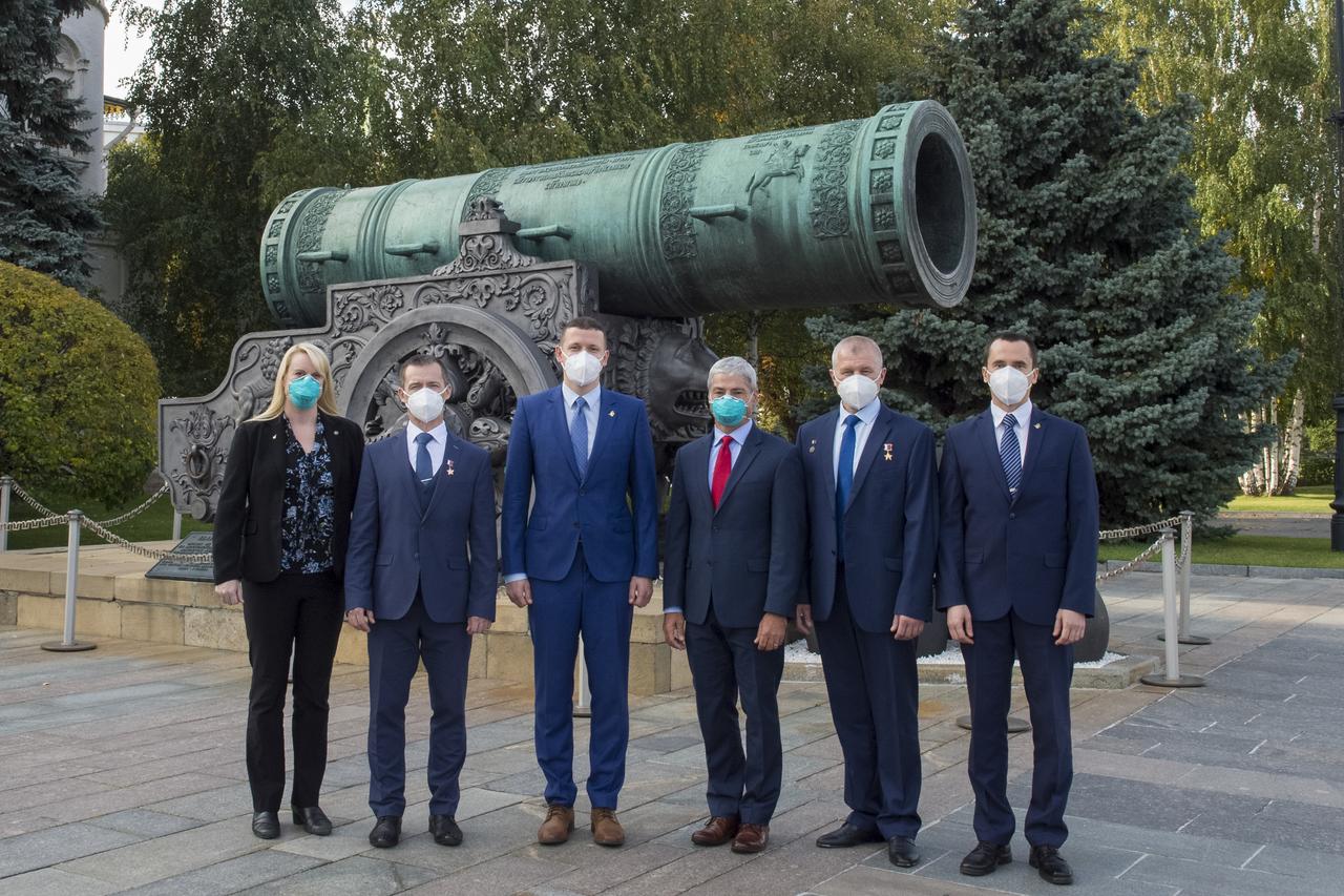 From left to right, Expedition 64 prime crew members, NASA astronaut Kate Rubins, Russian cosmonaut Sergey Ryzhikov of Roscosmos, Russian cosmonaut Sergey Kud-Sverchkov of Roscosmos and Expedition 64 backup crew members, NASA astronaut Mark Vande Hei, Russian cosmonaut Oleg Novitskiy of Roscosmos, and Russian cosmonaut Petr Dubrov of Roscosmos, pose for a photo in front of the Tsar Cannon in Red Square after laying flowers at the site where Russian space icons are interred as part of traditional pre-launch ceremonies, Thursday, Sept. 24, 2020 in Moscow. Photo Credit: (NASA/GCTC/Irina Spector)