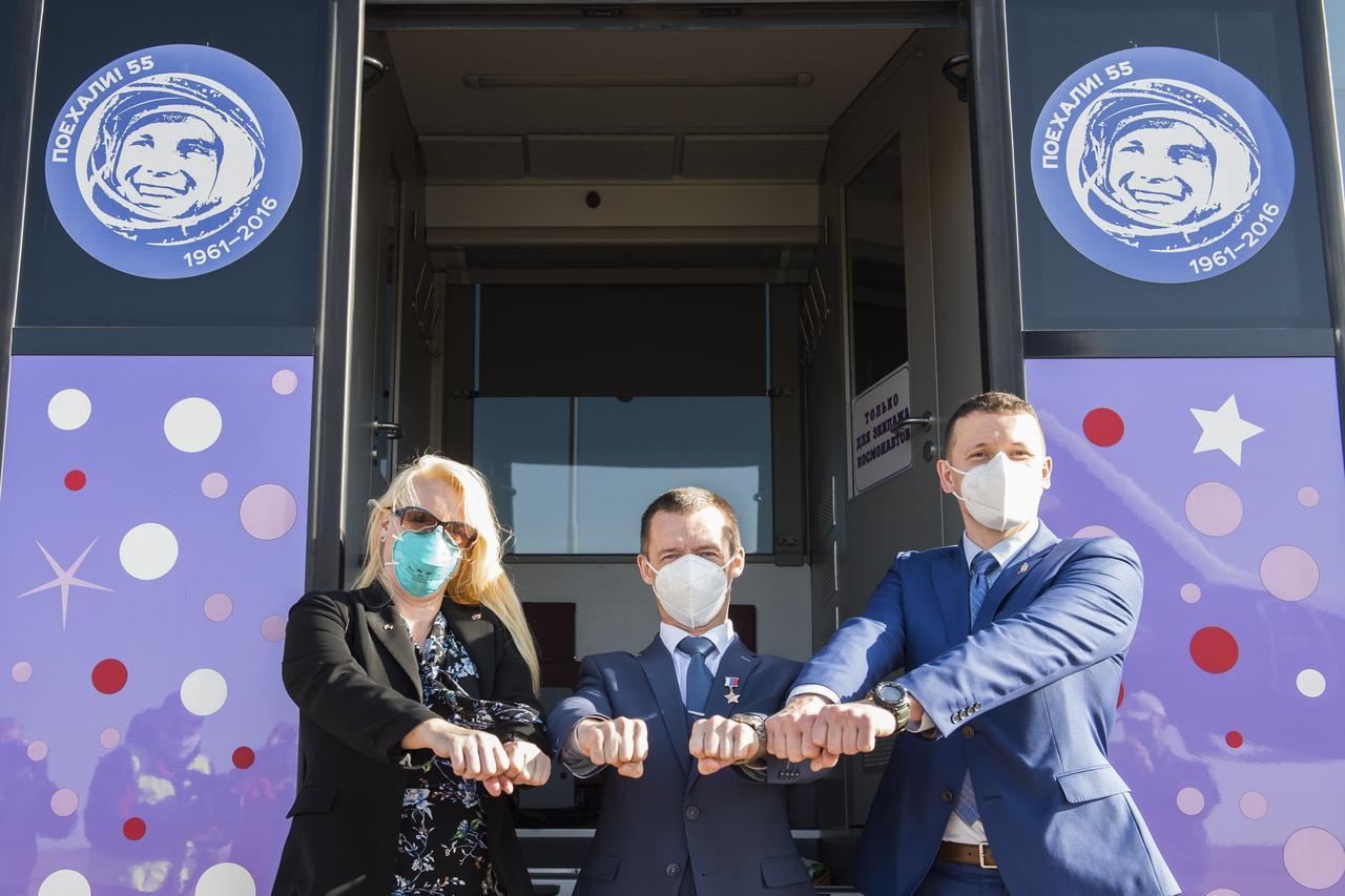 Expedition 64 prime crew members, NASA astronaut Kate Rubins, left, Russian cosmonaut Sergey Ryzhikov of Roscosmos, center, and Russian cosmonaut Sergey Kud-Sverchkov of Roscosmos pose for a photo at the bus after arriving in Baikonur, Kazakhstan from the Gagarin Cosmonaut Training Center, Sunday, Sept. 27, 2020. They are scheduled to launch from the Baikonur Cosmosdrome on a Soyuz rocket October 14. Photo Credit: (NASA/GCTC/Andrey Shelepin)