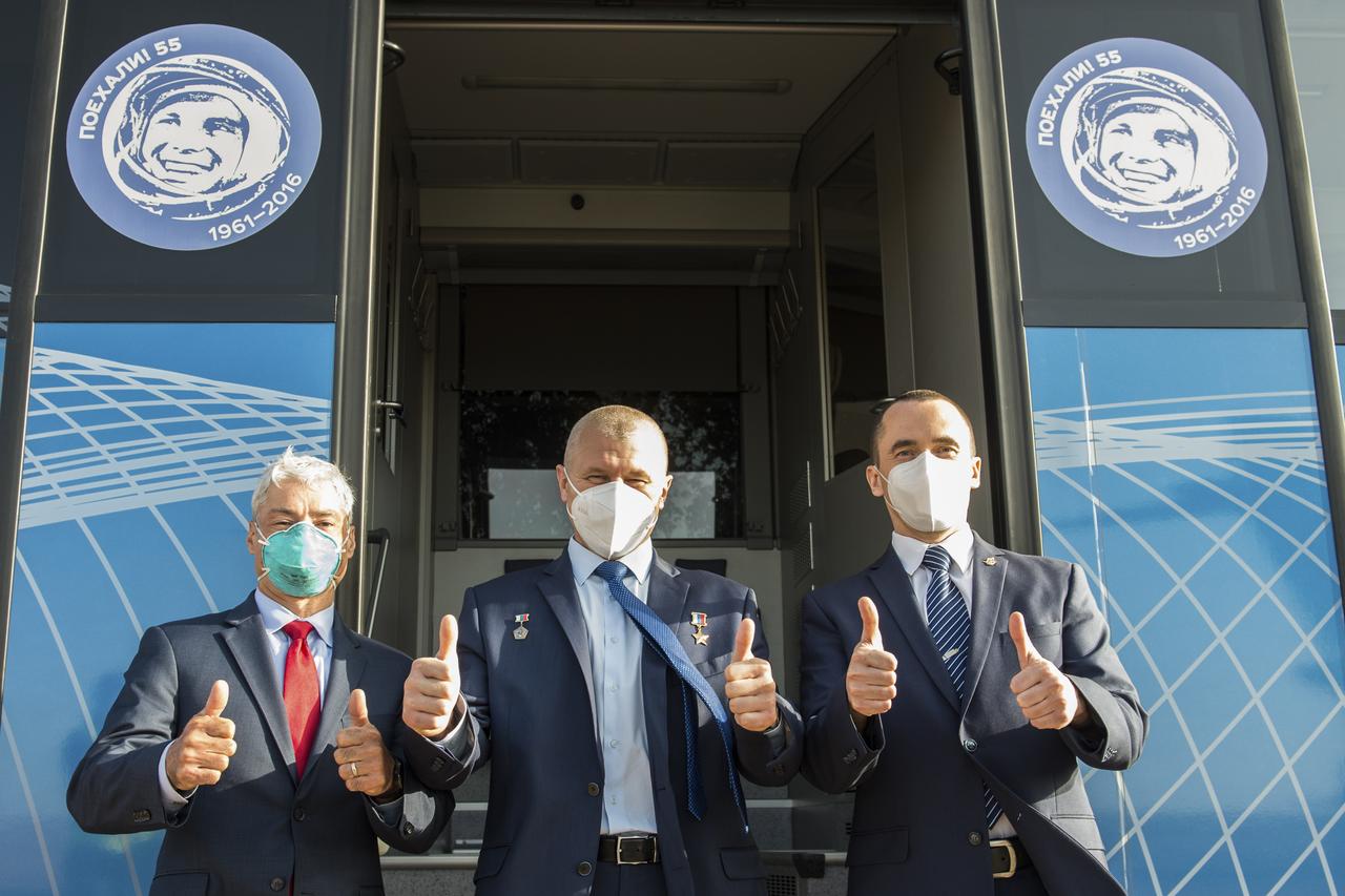 Expedition 64 backup crew members NASA astronaut Mark Vande Hei, left, Russian cosmonaut Oleg Novitskiy of Roscosmos, center, and Russian cosmonaut Petr Dubrov of Roscosmos, pose for a photo at the bus after arriving in Baikonur, Kazakhstan from the Gagarin Cosmonaut Training Center, Sunday, Sept. 27, 2020. The prime crew is scheduled to launch from the Baikonur Cosmosdrome on a Soyuz rocket October 14. Photo Credit: (NASA/GCTC/Andrey Shelepin)