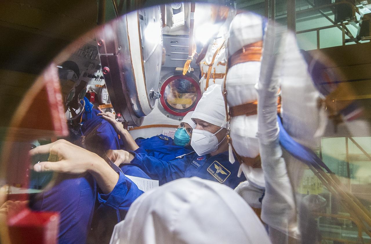 Expedition 64 NASA astronaut Kate Rubins, back, and Russian cosmonauts Sergey Ryzhikov, middle, and Sergey Kud-Sverchkov of Roscosmos are seen inside the Soyuz MS-17 spacecraft during a fit check, Monday, Sept. 28, 2020, at the Baikonur Cosmodrome in Kazakhstan. The trio are preparing for launch to the International Space Station in their Soyuz MS-17 spacecraft from the Baikonur Cosmodrome in Kazakhstan on October 14, Baikonur time. Photo Credit: (NASA/GCTC/Andrey Shelepin)