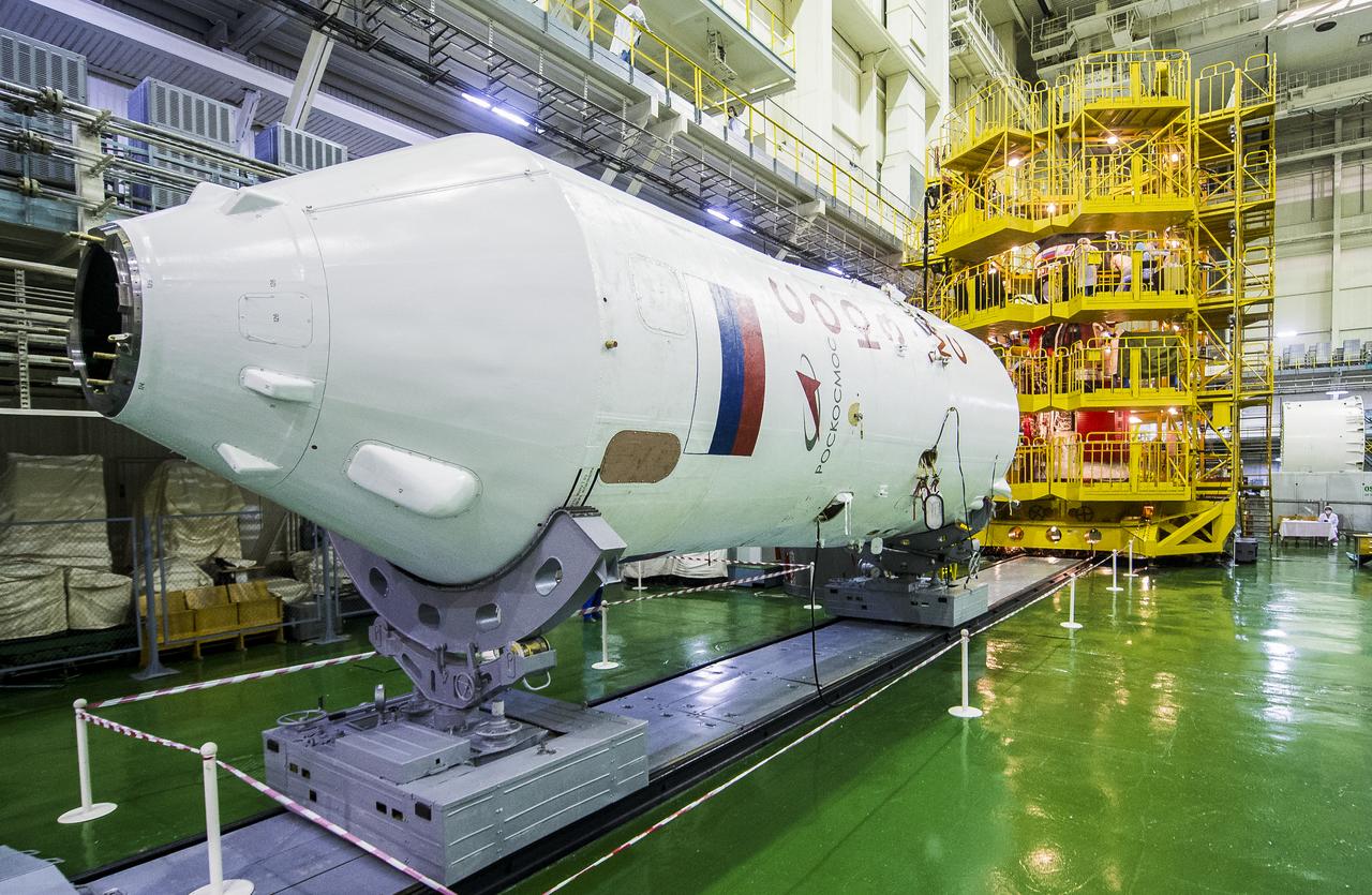 The Soyuz fairing is seen laying horizontal in front of the Soyuz MS-17 spacecraft as Expedition 64 Russian cosmonauts Sergey Ryzhikov and Sergey Kud-Sverchkov of Roscosmos, and NASA astronaut Kate Rubins perform their fit checks, Monday, Sept. 28, 2020, at the Baikonur Cosmodrome in Kazakhstan. The trio are preparing for launch to the International Space Station in their Soyuz MS-17 spacecraft from the Baikonur Cosmodrome in Kazakhstan on October 14, Baikonur time. Photo Credit: (NASA/GCTC/Andrey Shelepin)