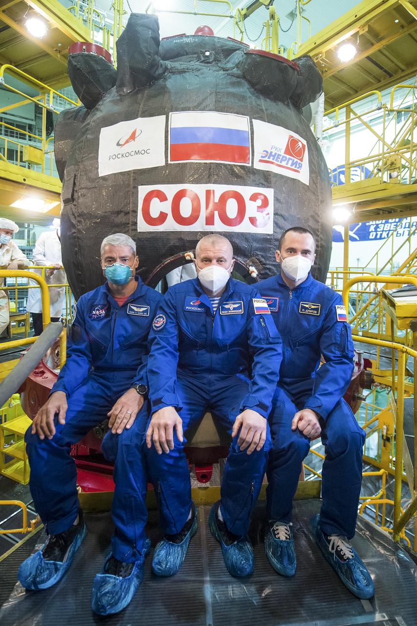 Expedition 64 backup crew members NASA astronaut Mark Vande Hei, left, and Russian cosmonauts Oleg Novitskiy, center, and Petr Dubrov, right, of Roscosmos take a moment during the Soyuz MS-17 spacecraft fit check to pose for a photograph, Monday, Sept. 28, 2020, at the Baikonur Cosmodrome in Kazakhstan. The prime crew members Russian cosmonauts Sergey Ryzhikov, Sergey Kud-Sverchkov of Roscosmos, and NASA astronaut Kate Rubins are preparing for launch to the International Space Station in their Soyuz MS-17 spacecraft from the Baikonur Cosmodrome in Kazakhstan on October 14, Baikonur time. Photo Credit: (NASA/GCTC/Andrey Shelepin)