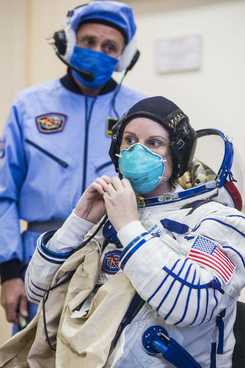Expedition 64 NASA astronaut Kate Rubins dons her Sokol suit during the Soyuz MS-17 spacecraft fit check with Russian cosmonauts Sergey Ryzhikov and Sergey Kud-Sverchkov of Roscosmos, Monday, Sept. 28, 2020, at the Baikonur Cosmodrome in Kazakhstan. The trio are preparing for launch to the International Space Station in their Soyuz MS-17 spacecraft from the Baikonur Cosmodrome in Kazakhstan on October 14, Baikonur time. Photo Credit: (NASA/GCTC/Andrey Shelepin)