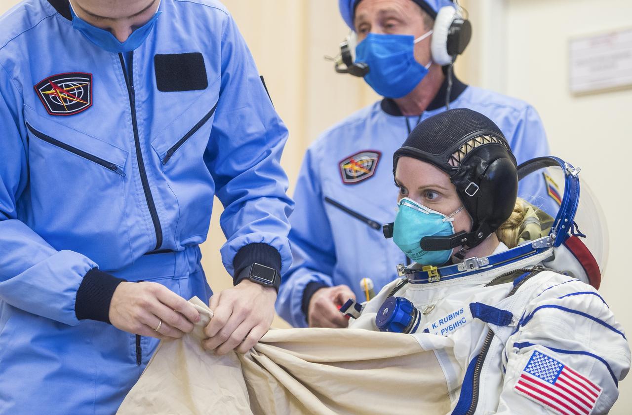 Expedition 64 NASA astronaut Kate Rubins dons her Sokol suit during the Soyuz MS-17 spacecraft fit check with Russian cosmonauts Sergey Ryzhikov and Sergey Kud-Sverchkov of Roscosmos, Monday, Sept. 28, 2020, at the Baikonur Cosmodrome in Kazakhstan. The trio are preparing for launch to the International Space Station in their Soyuz MS-17 spacecraft from the Baikonur Cosmodrome in Kazakhstan on October 14, Baikonur time. Photo Credit: (NASA/GCTC/Andrey Shelepin)