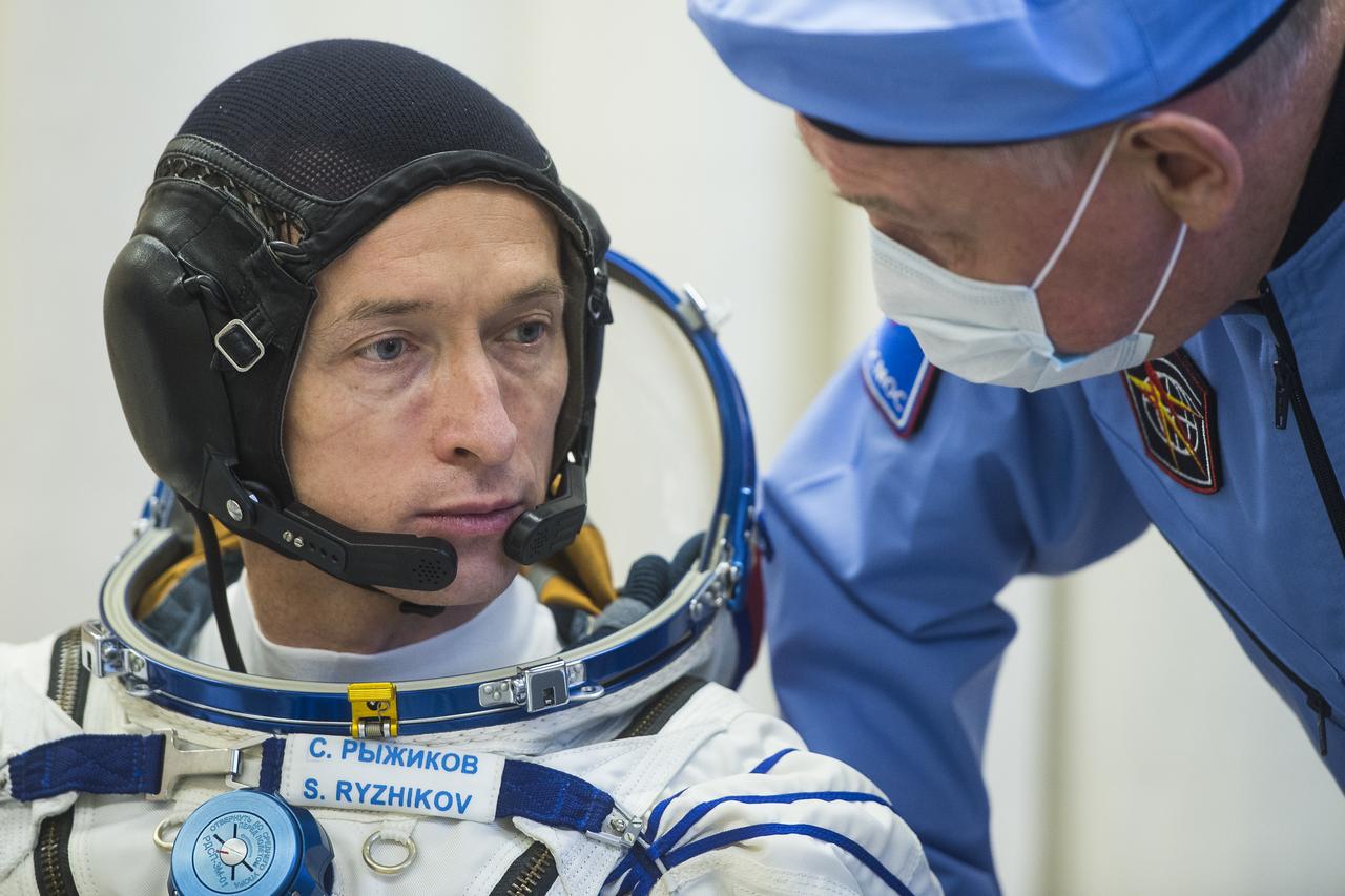 Expedition 64 Russian cosmonaut Sergey Ryzhikov of Roscosmos is seen after donning his Sokol suit during the Soyuz MS-17 spacecraft fit check with fellow Russian cosmonaut Sergey Kud-Sverchkov and NASA astronaut Kate Rubins, Monday, Sept. 28, 2020, at the Baikonur Cosmodrome in Kazakhstan. The trio are preparing for launch to the International Space Station in their Soyuz MS-17 spacecraft from the Baikonur Cosmodrome in Kazakhstan on October 14, Baikonur time. Photo Credit: (NASA/GCTC/Andrey Shelepin)
