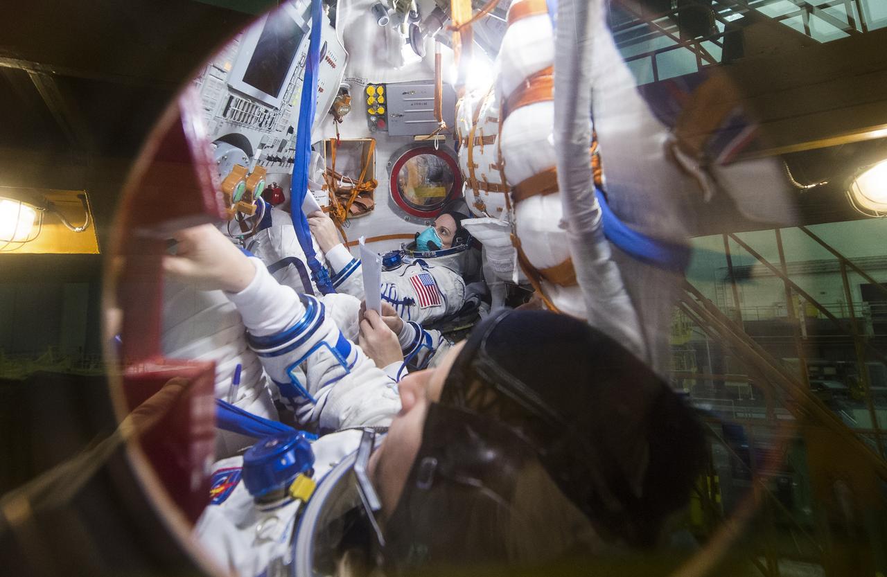 Expedition 64 NASA astronaut Kate Rubins, back, and Russian cosmonauts Sergey Ryzhikov, middle, and Sergey Kud-Sverchkov, front, of Roscosmos, are seen inside the Soyuz MS-17 spacecraft during a fit check, Monday, Sept. 28, 2020, at the Baikonur Cosmodrome in Kazakhstan. The trio are preparing for launch to the International Space Station in their Soyuz MS-17 spacecraft from the Baikonur Cosmodrome in Kazakhstan on October 14, Baikonur time. Photo Credit: (NASA/GCTC/Andrey Shelepin)