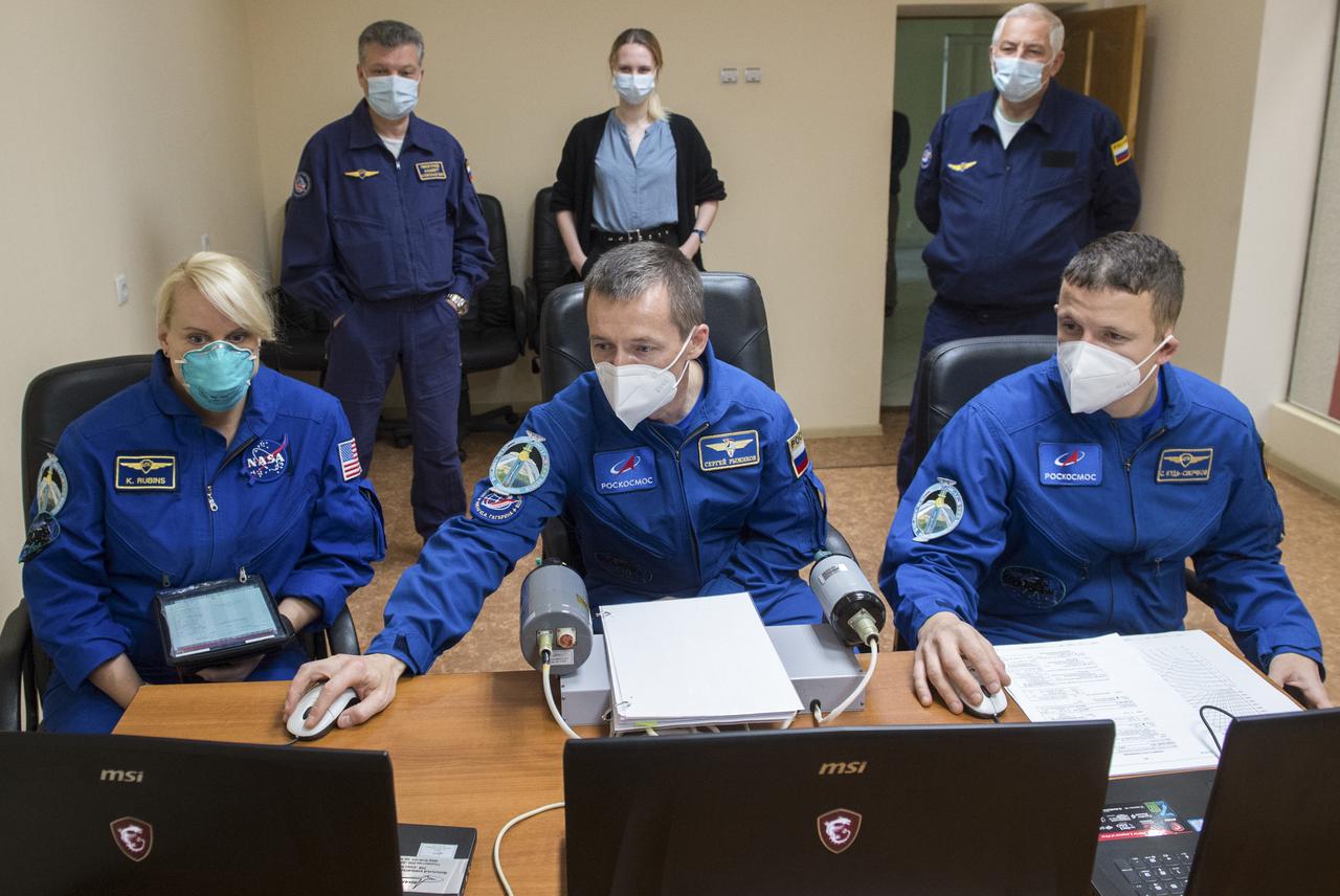 Expedition 64 crew members NASA astronaut Kate Rubins, left, and Russian cosmonauts Sergey Ryzhikov, center, and Sergey Kud-Sverchkov, right, of Roscosmos practice rendezvous techniques on a laptop simulator, Tuesday, Oct. 6, 2020, at the Cosmonaut Hotel in Baikonur, Kazakhstan. The trio are scheduled to launch to the International Space Station aboard the Soyuz MS-17 spacecraft on October 14. Photo Credit: (NASA/GCTC/Andrey Shelepin)