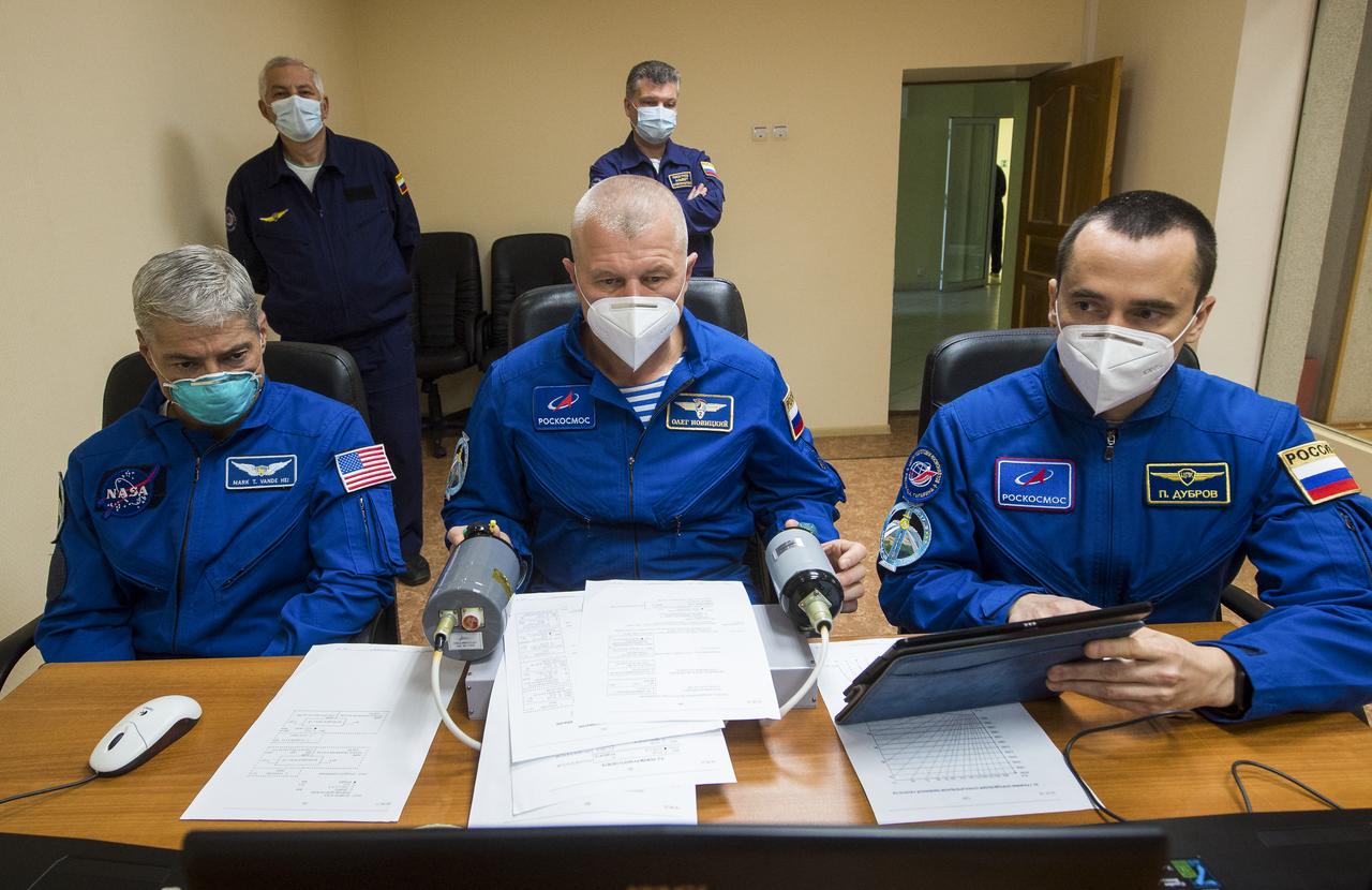 Expedition 64 backup crew members NASA astronaut Mark Vande Hei, left, and Russian cosmonauts Oleg Novitskiy, center, and Petr Dubrov, right, of Roscosmos practice rendezvous techniques on a laptop simulator, Tuesday, Oct. 6, 2020, at the Cosmonaut Hotel in Baikonur, Kazakhstan. Expedition 64 prime crew members Sergey Ryzhikov of Roscosmos, Sergey Kud-Sverchkov of Roscosmos, and Kate Rubins of NASA, are scheduled to launch to the International Space Station aboard the Soyuz MS-17 spacecraft on October 14. Photo Credit: (NASA/GCTC/Andrey Shelepin)