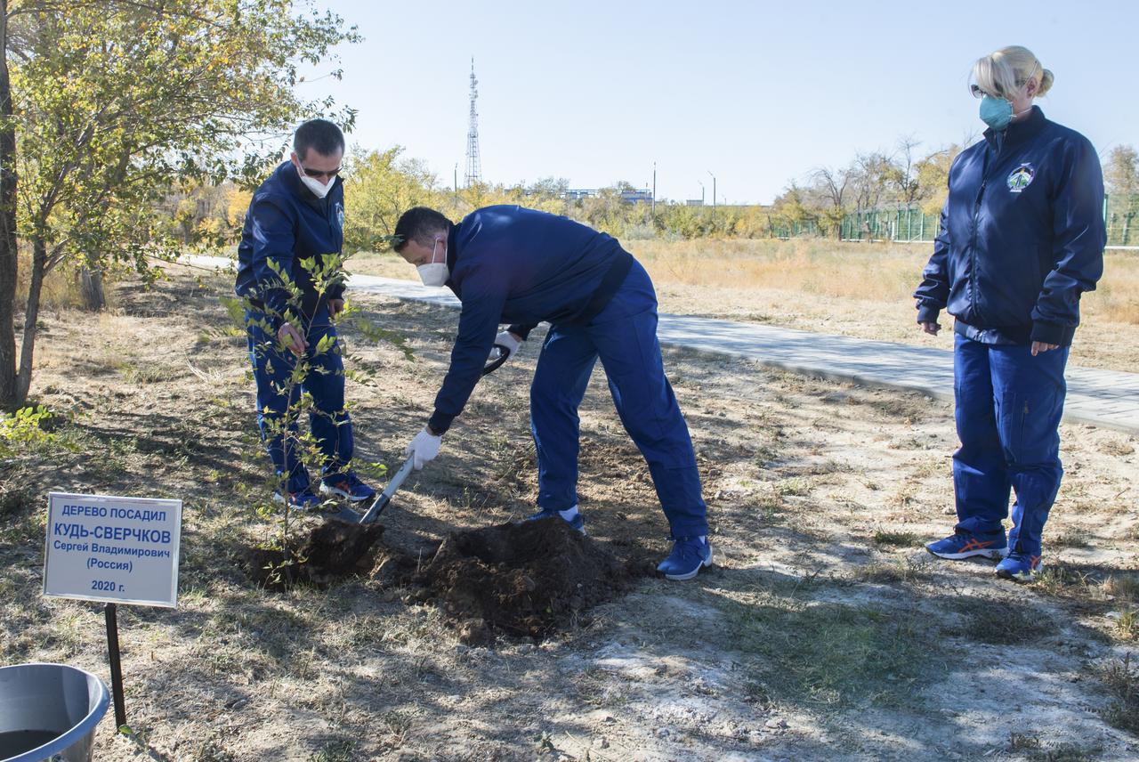 Expedition 64 Russian cosmonaut Sergey Kud-Sverchkov of Roscosmos, center, plants a tree bearing his name as part of traditional pre-launch activities, Tuesday, Oct. 6, 2020, at the Cosmonaut Hotel in Baikonur, Kazakhstan. Looking on are crew mates Sergey Ryzhikov of Roscosmos, left, and Kate Rubins of NASA, right.The trio are scheduled to launch to the International Space Station aboard the Soyuz MS-17 spacecraft on October 14. Photo Credit: (NASA/GCTC/Andrey Shelepin)
