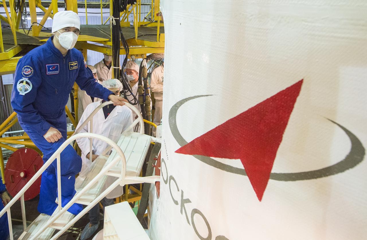 Expedition 64 backup crew member Petr Dubrov of Roscosmos is seen as he climbs inside the Soyuz MS-17 spacecraft during the final fit check, Wednesday, Oct. 7, 2020, at the Baikonur Cosmodrome in Kazakhstan. Expedition 64 Soyuz commander Sergey Ryzhikov of Roscosmos, flight engineer Sergey Kud-Sverchkov of Roscosmos, and flight engineer Kate Rubins of NASA, are scheduled to launch to the International Space Station aboard the Soyuz MS-17 spacecraft on October 14. Photo Credit: (NASA/GCTC/Andrey Shelepin)