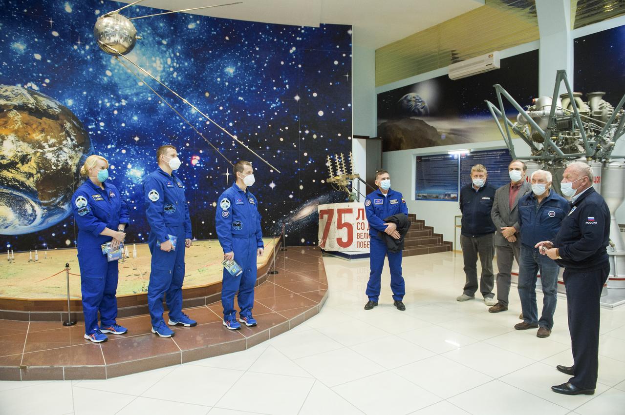 Expedition 64 NASA astronaut Kate Rubins, left, and Russian cosmonauts Sergey Kud-Sverchkov, center, and Sergey Ryzhikov of Roscosmos, right, are seen during a traditional tour of the Baikonur Cosmodrome Museum, Wednesday, Oct. 7, 2020, Baikonur Cosmodrome in Kazakhstan. The trio are scheduled to launch to the International Space Station aboard the Soyuz MS-17 spacecraft on October 14. Photo Credit: (NASA/GCTC/Andrey Shelepin)