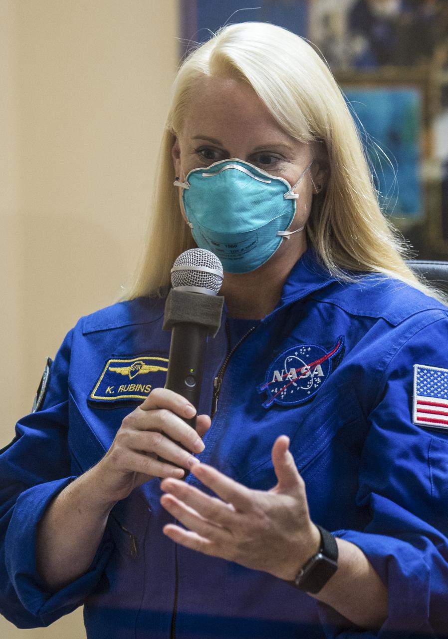Expedition 64 NASA astronaut Kate Rubins is seen in quarantine, behind glass, during a press conference, Tuesday, Oct. 13, 2020, at the Cosmonaut Hotel in Baikonur, Kazakhstan.  Rubins, and Russian cosmonauts Sergey Ryzhikov and Sergey Kud-Sverchkov of Roscosmos are scheduled to launch to the International Space Station aboard the Soyuz MS-17 spacecraft on October 14.  Photo Credit: (NASA/GCTC/Andrey Shelepin)