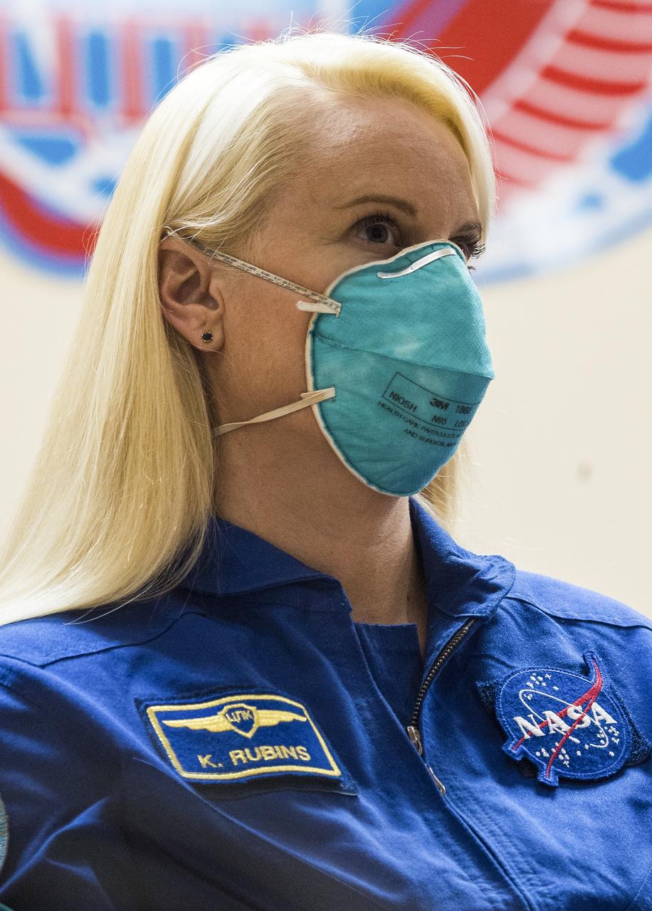 Expedition 64 NASA astronaut Kate Rubins is seen in quarantine, behind glass, during a press conference, Tuesday, Oct. 13, 2020, at the Cosmonaut Hotel in Baikonur, Kazakhstan.  Rubins, and Russian cosmonauts Sergey Ryzhikov and Sergey Kud-Sverchkov of Roscosmos are scheduled to launch to the International Space Station aboard the Soyuz MS-17 spacecraft on October 14.  Photo Credit: (NASA/GCTC/Andrey Shelepin)