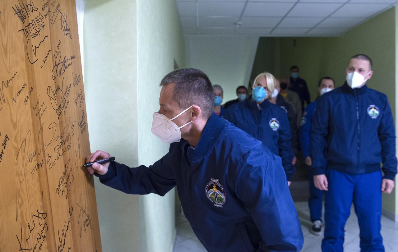 Expedition 64 Russian cosmonaut Sergey Ryzhikov of Roscosmos performs the traditional door signing at the Cosmonaut Hotel prior to departing the hotel for launch on a Soyuz rocket with fellow crewmates Sergey Kud-Sverchkov of Roscosmos and Kate Rubins of NASA, Wednesday, Oct. 14, 2020, in Baikonur, Kazakhstan. Ryzhikov, Kud-Sverchkov, and Rubins launched in their Soyuz MS-17 spacecraft at 1:45 a.m. EDT to begin a six-month mission onboard the International Space Station. Photo Credit: (NASA/GCTC/Andrey Shelepin)