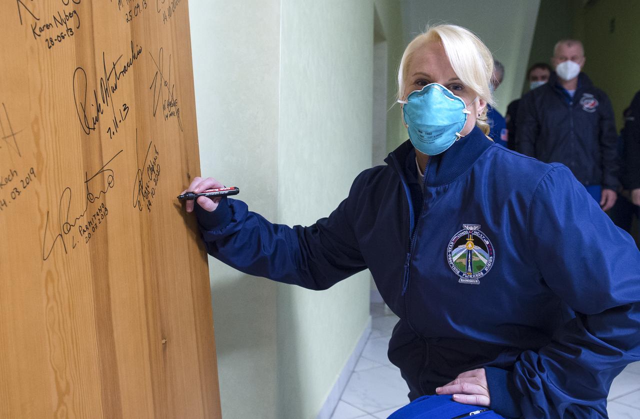 Expedition 64 NASA astronaut Kate Rubins performs the traditional door signing at the Cosmonaut Hotel prior to departing the hotel for launch on a Soyuz rocket with fellow crewmates Sergey Ryzhikov and Sergey Kud-Sverchkov of Roscosmos, Wednesday, Oct. 14, 2020, in Baikonur, Kazakhstan.  Ryzhikov, Kud-Sverchkov, and Rubins launched in their Soyuz MS-17 spacecraft at 1:45 a.m. EDT to begin a six-month mission onboard the International Space Station.  Photo Credit: (NASA/GCTC/Andrey Shelepin)