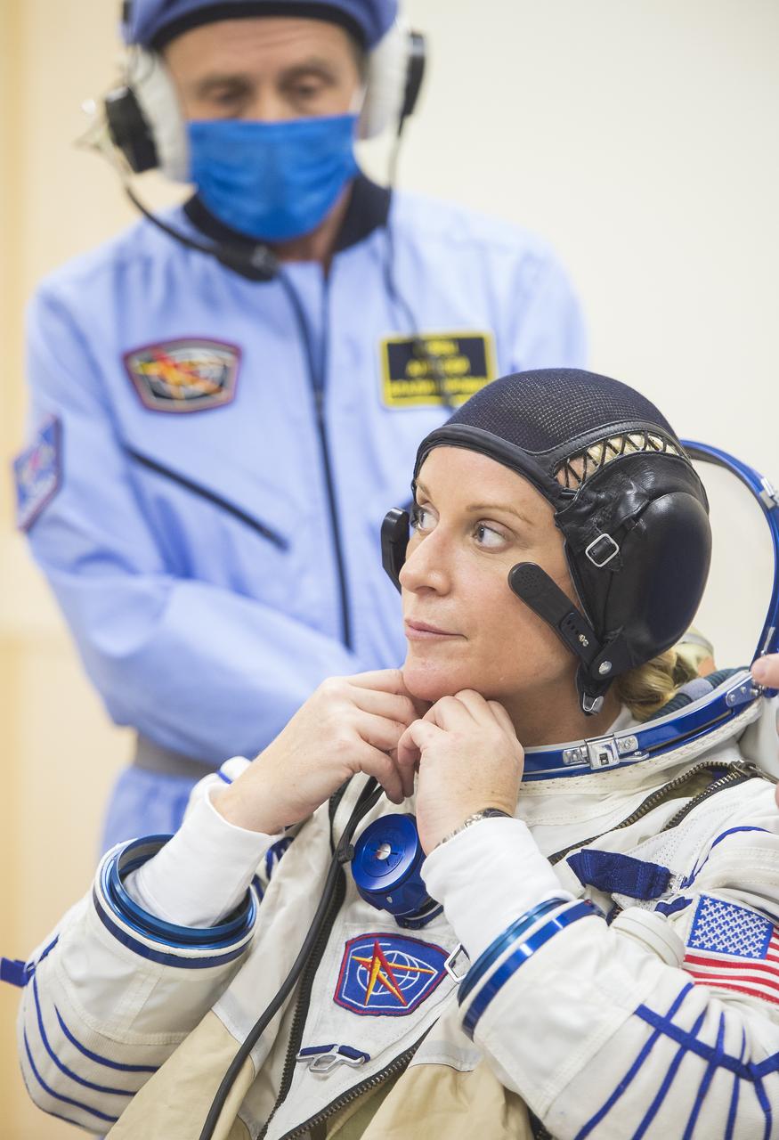 Expedition 64 NASA astronaut Kate Rubins is helped into her Russian Sokol suit as she and fellow cremates, Sergey Ryzhikov and Sergey Kud-Sverchkov of Roscosmos prepare for their Soyuz launch to the International Space Station Wednesday, Oct. 14, 2020, at the Baikonur Cosmodrome in Kazakhstan. The trio launched at 1:45 a.m. EDT to begin a six-month mission aboard the International Space Station. Photo Credit: (NASA/GCTC/Andrey Shelepin)