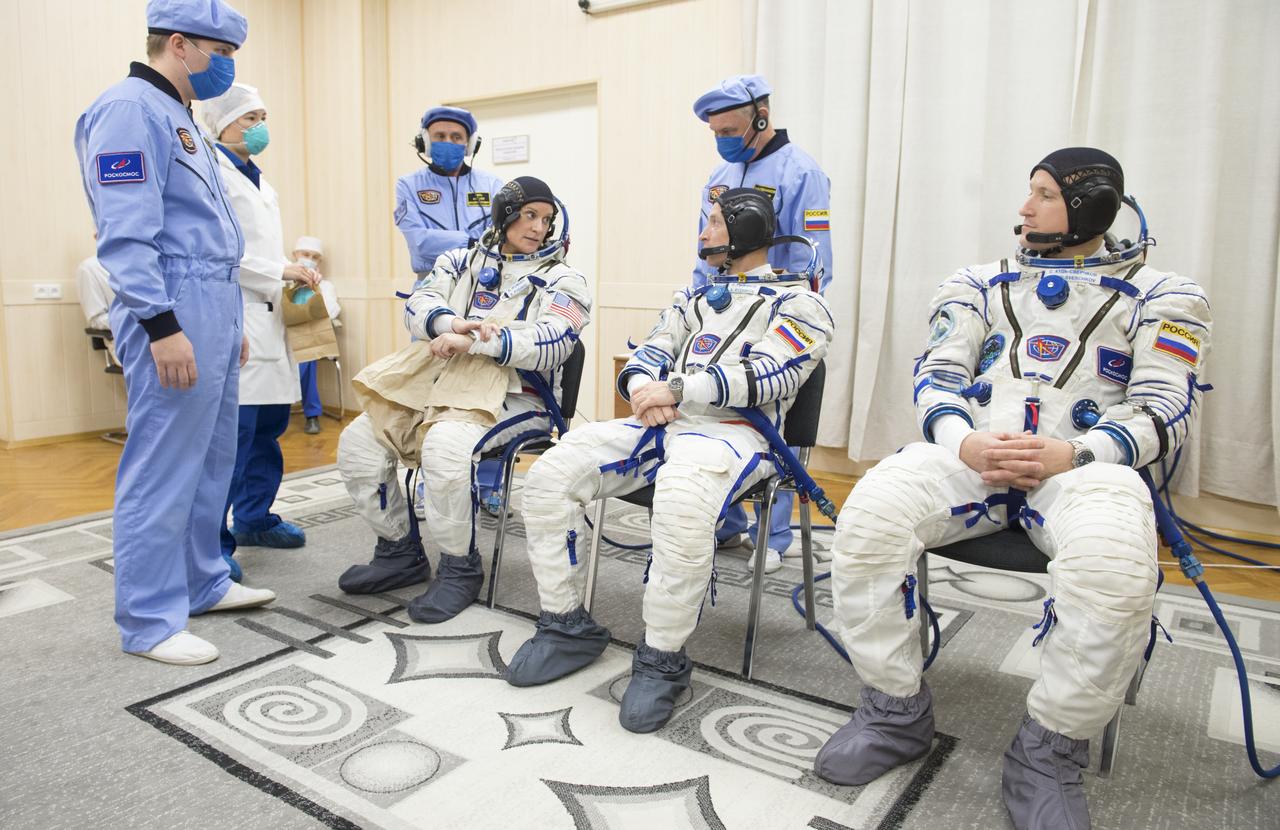 Expedition 64 NASA astronaut Kate Rubins, left, and Russian cosmonauts Sergey Ryzhikov, center, and Sergey Kud-Sverchkov, right, of Roscosmos are seen after while donning their Russian Sokol suits as they prepare for their Soyuz launch to the International Space Station Wednesday, Oct. 14, 2020 at the Baikonur Cosmodrome in Kazakhstan.  The trio launched at 1:45 a.m. EDT to begin a six-month mission aboard the International Space Station. Photo Credit: (NASA/GCTC/Andrey Shelepin)