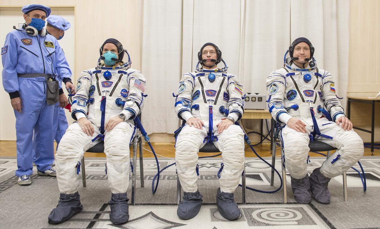 Expedition 64 NASA astronaut Kate Rubins, left, and Russian cosmonauts Sergey Ryzhikov, center, and Sergey Kud-Sverchkov, right, of Roscosmos are seen after donning their Russian Sokol suits as they prepare for their Soyuz launch to the International Space Station Wednesday, Oct. 14, 2020 in Baikonur, Kazakhstan.  The trio launched at 1:45 a.m. EDT to begin a six-month mission aboard the International Space Station. Photo Credit: (NASA/GCTC/Andrey Shelepin)