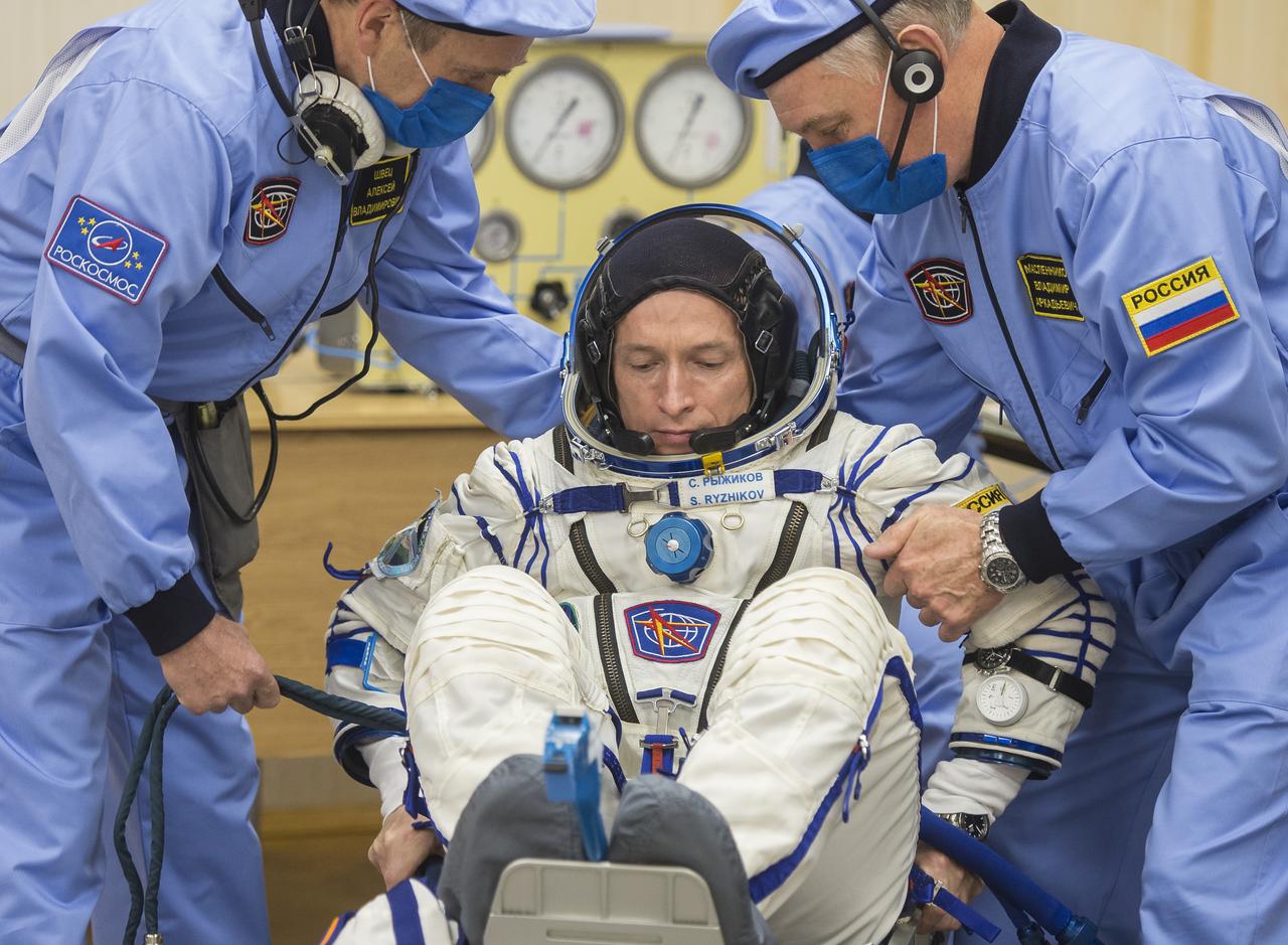 Expedition 64 Russian cosmonaut Sergey Ryzhikov of Roscosmos is seen as he prepares to have his Russian Sokol suit pressure checked as he and fellow crewmates Sergey Kud-Sverchkov of Roscosmos and Kate Rubins of NASA prepare for their Soyuz launch to the International Space Station Wednesday, Oct. 14, 2020, at the Baikonur Cosmodrome in Kazakhstan. The trio launched at 1:45 a.m. EDT to begin a six-month mission aboard the International Space Station. Photo Credit: (NASA/GCTC/Andrey Shelepin)