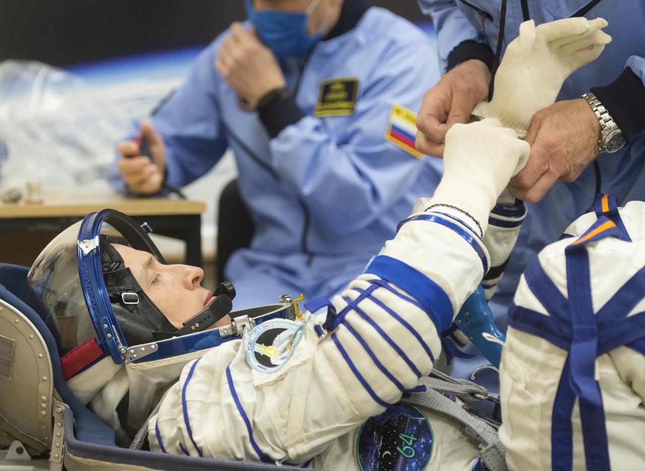 Expedition 64 Russian cosmonaut Sergey Ryzhikov of Roscosmos is seen as he prepares to have his Russian Sokol suit pressure checked as he and fellow crewmates Sergey Kud-Sverchkov of Roscosmos and Kate Rubins of NASA prepare for their Soyuz launch to the International Space Station Wednesday, Oct. 14, 2020, at the Baikonur Cosmodrome in Kazakhstan. The trio launched at 1:45 a.m. EDT to begin a six-month mission aboard the International Space Station. Photo Credit: (NASA/GCTC/Andrey Shelepin)