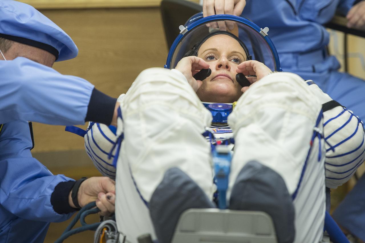 Expedition 64 NASA astronaut Kate Rubins is seen as she prepares to have her Russian Sokol suit pressure checked as she and fellow crewmates Sergey Kud-Sverchkov and Sergey Ryzhikov of Roscosmos prepare for their Soyuz launch to the International Space Station Wednesday, Oct. 14, 2020, at the Baikonur Cosmodrome in Kazakhstan. The trio launched at 1:45 a.m. EDT to begin a six-month mission aboard the International Space Station. Photo Credit: (NASA/GCTC/Andrey Shelepin)
