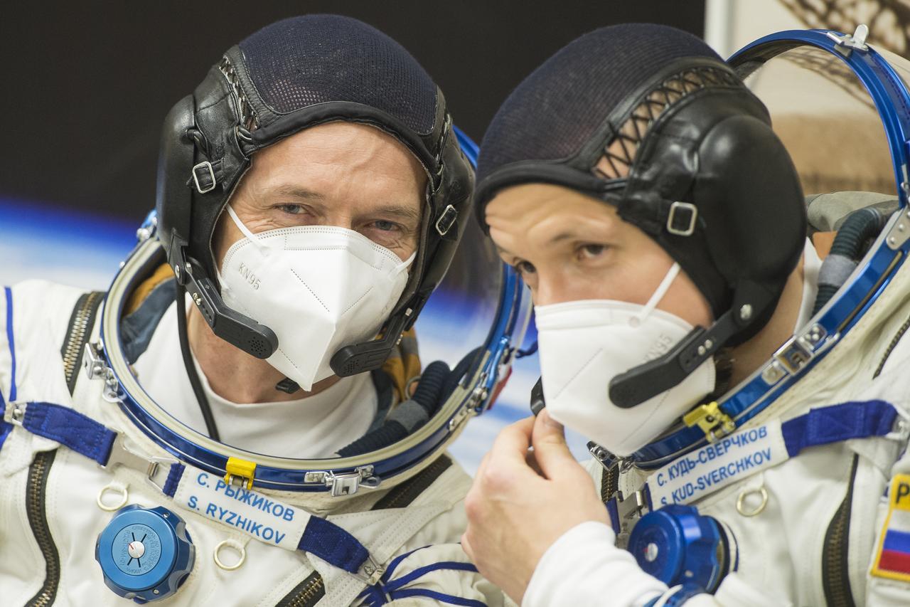 Expedition 64 Russian cosmonauts Sergey Ryzhikov, left, and Sergey Kud-Sverchkov, right, of Roscosmos are seen following Russian Sokol suit pressure checks as they and fellow crewmate NASA astronaut Kate Rubins prepare for their Soyuz launch to the International Space Station Wednesday, Oct. 14, 2020, at the Baikonur Cosmodrome in Kazakhstan. The trio launched at 1:45 a.m. EDT to begin a six-month mission aboard the International Space Station. Photo Credit: (NASA/GCTC/Andrey Shelepin)