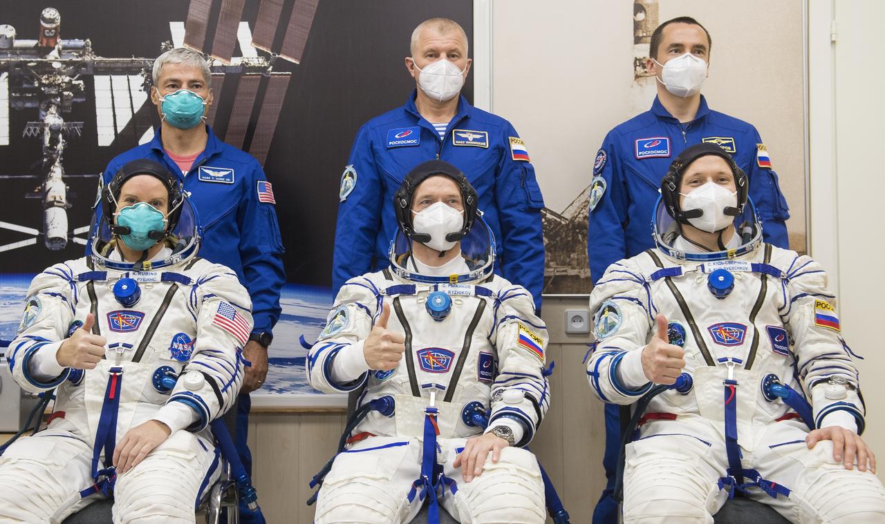 Expedition 64 prime and backup crew members pose for a picture following Russian Sokol suit pressure checks, Wednesday, Oct. 14, 2020, at the Baikonur Cosmodrome in Kazakhstan. From left to right seated are prime crew members Kate Rubins of NASA, Sergey Ryzhikov of Roscosmos, and Sergey Kud-Sverchkov of Roscosmos; standing are backup crew members Mark Vande Hei of NASA, Oleg Novitskiy of Roscosmos, and Petr Dubov of Roscosmos. Rubins, Ryzhikov, and Kud-Sverchkov launched at 1:45 a.m. EDT to begin a six-month mission aboard the International Space Station. Photo Credit: (NASA/GCTC/Andrey Shelepin)