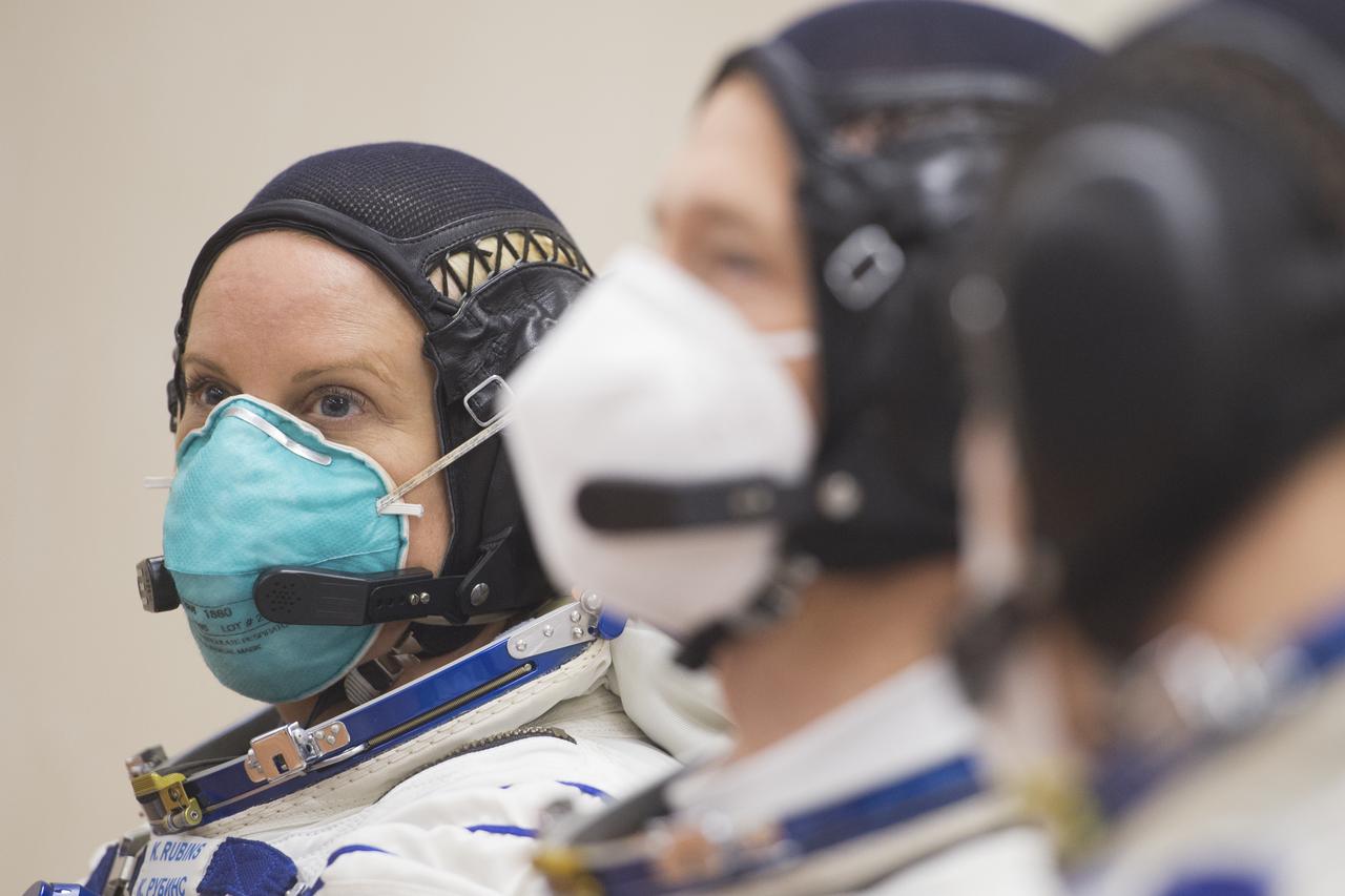 Expedition 64 NASA astronaut Kate Rubins is seen with fellow crewmates Sergey Ryzhikov and Sergey Kud-Sverchkov of Roscosmos as they speak with Roscosmos and NASA managers after having their Russian Sokol suits pressure checked, Wednesday, Oct. 14, 2020, at the Baikonur Cosmodrome in Kazakhstan. The trio launched at 1:45 a.m. EDT to begin a six-month mission aboard the International Space Station. Photo Credit: (NASA/GCTC/Andrey Shelepin)