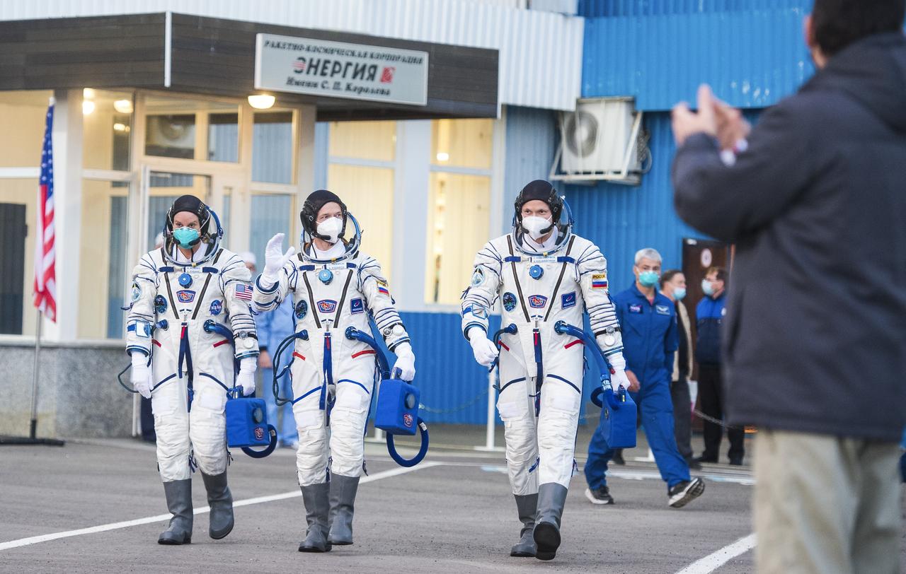 Expedition 64 NASA astronaut Kate Rubins, left, and Russian cosmonauts Sergey Ryzhikov, center, and Sergey Kud-Sverchkov, right, of Roscosmos are seen as they depart Building 254 to head to their launch onboard the Soyuz MS-17 spacecraft, Wednesday, Oct. 14, 2020, at the Baikonur Cosmodrome in Kazakhstan. The trio launched at 1:45 a.m. EDT to begin a six-month mission aboard the International Space Station. Photo Credit: (NASA/GCTC/Andrey Shelepin)