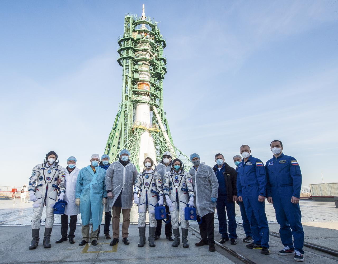 Expedition 64 crewmembers Sergey Kud-Sverchkov of Roscosmos, Sergey Ryzhikov of Roscosmos, and Kate Rubins of NASA pose for a group photograph with Roscosmos Director General Dmitry Rogozin, mission management, and the backup crew at the launch pad, Wednesday, Oct. 14, 2020, at the Baikonur Cosmodrome in Kazakhstan. Kud-Sverchkov, Ryzhikov, and Rubins launched at 1:45 a.m. EDT to begin six-month mission onboard the International Space Station. Photo Credit: (NASA/GCTC/Andrey Shelepin)