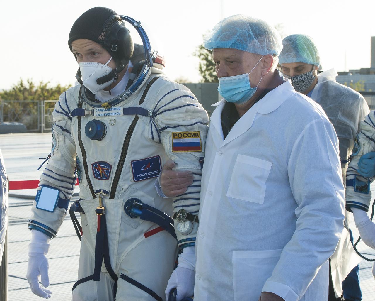 Expedition 64 Russian cosmonaut Sergey Kud-Sverchkov walks to board the Soyuz MS-17 spacecraft prior to launch with Sergey Ryzhikov of Roscosmos and Kate Rubins of NASA, Wednesday, Oct. 14, 2020, at the Baikonur Cosmodrome in Kazakhstan.  The trio launched at 1:45 a.m. EDT to begin a six-month mission aboard the International Space Station. Photo Credit: (NASA/GCTC/Andrey Shelepin)