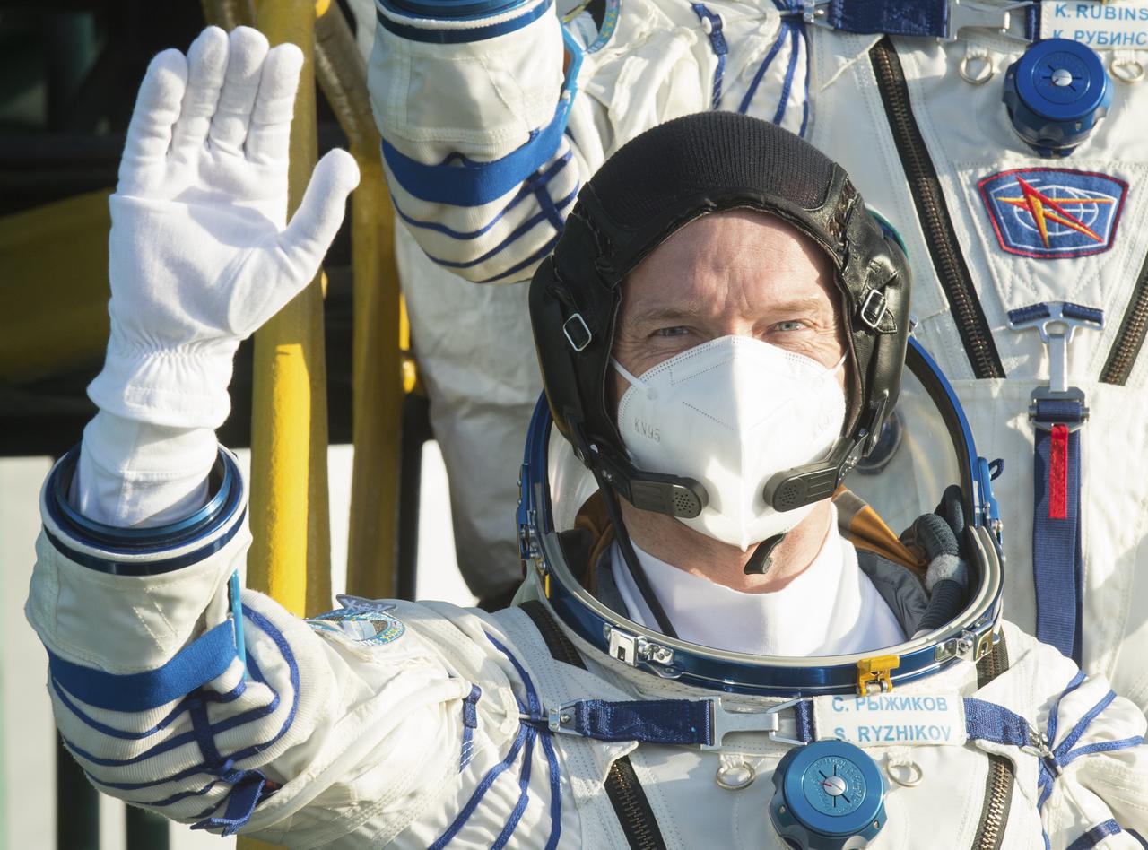 Expedition 64 Russian cosmonaut Sergey Ryzhikov of Roscosmos, waves farewell prior to boarding the Soyuz MS-17 spacecraft for launch with fellow crewmates Sergey Kud-Sverchkov of Roscosmos and Kate Rubins of NASA, Wednesday, Oct. 14, 2020, at the Baikonur Cosmodrome in Kazakhstan. The trio launched at 1:45 a.m. EDT to begin a two-orbit, three-hour flight to reach the International Space Station. Photo Credit: (NASA/GCTC/Andrey Shelepin)