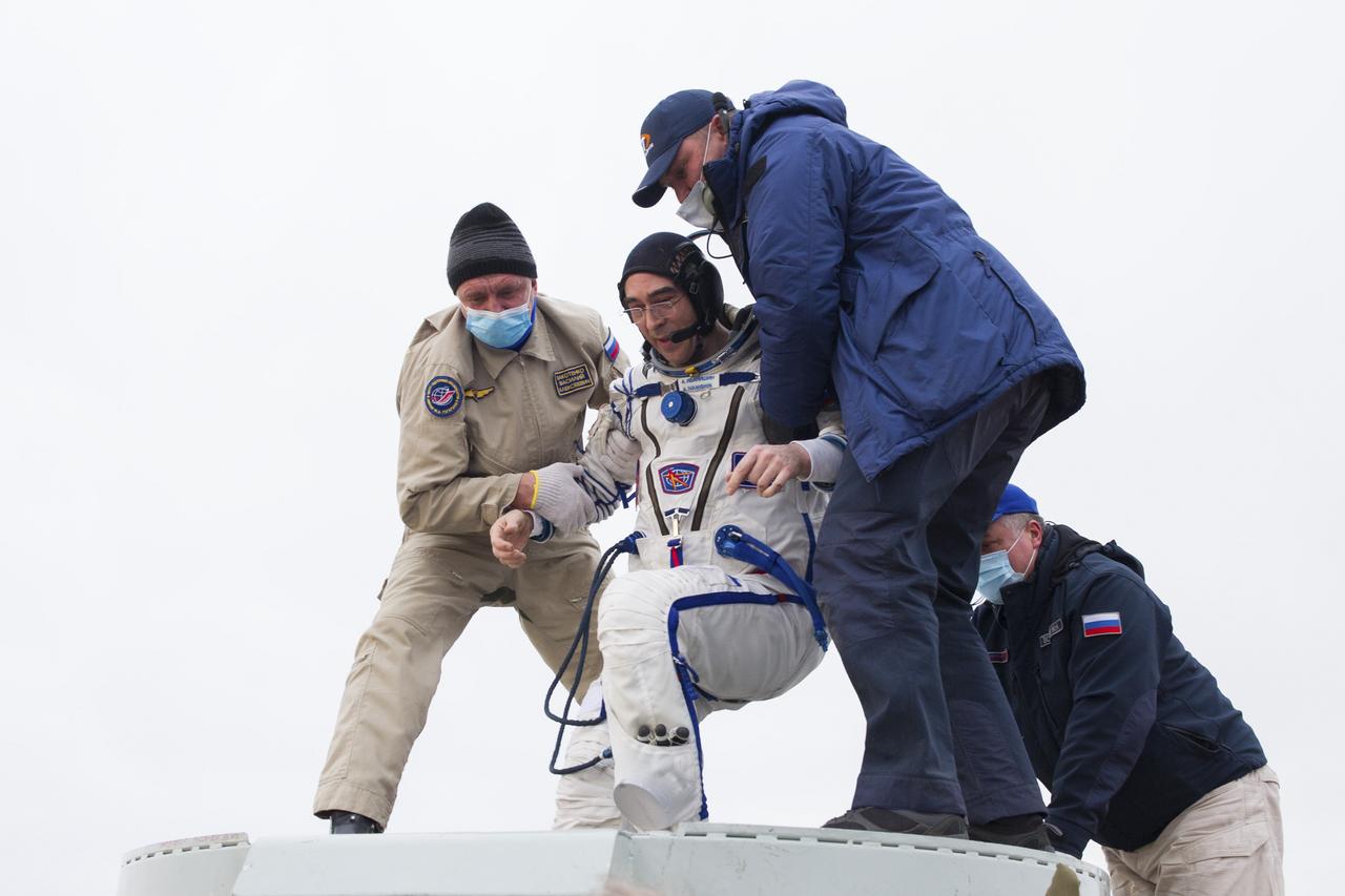 Expedition 63 Roscosmos cosmonaut Anatoly Ivanishin is helped out of the Soyuz MS-16 spacecraft just minutes after he, Roscosmos cosmonaut Ivan Vagner, and NASA astronaut Chris Cassidy, landed in a remote area near the town of Zhezkazgan, Kazakhstan on Thursday, October 22, 2020, Kazakh time (Oct. 21 Eastern time). Cassidy, Ivanishin and Vagner returned after 196 days in space having served as Expedition 62-63 crew members onboard the International Space Station. Photo Credit: (NASA/GCTC/Denis Derevtsov)