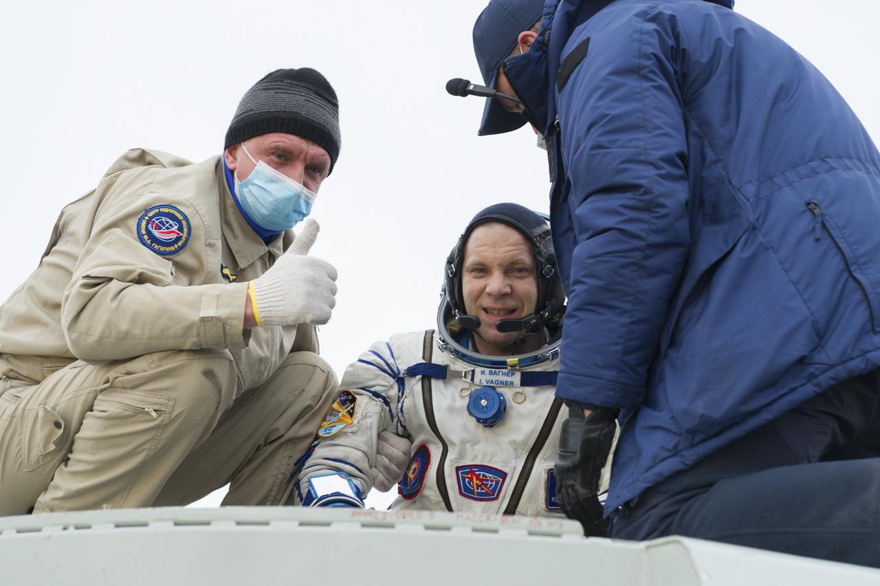 Expedition 63 Roscosmos cosmonaut Ivan Vagner is helped out of the Soyuz MS-16 spacecraft just minutes after he, Roscosmos cosmonaut Anatoly Ivanishin, and NASA astronaut Chris Cassidy, landed in a remote area near the town of Zhezkazgan, Kazakhstan on Thursday, October 22, 2020, Kazakh time (Oct. 21 Eastern time). Cassidy, Ivanishin and Vagner returned after 196 days in space having served as Expedition 62-63 crew members onboard the International Space Station. Photo Credit: (NASA/GCTC/Denis Derevtsov)