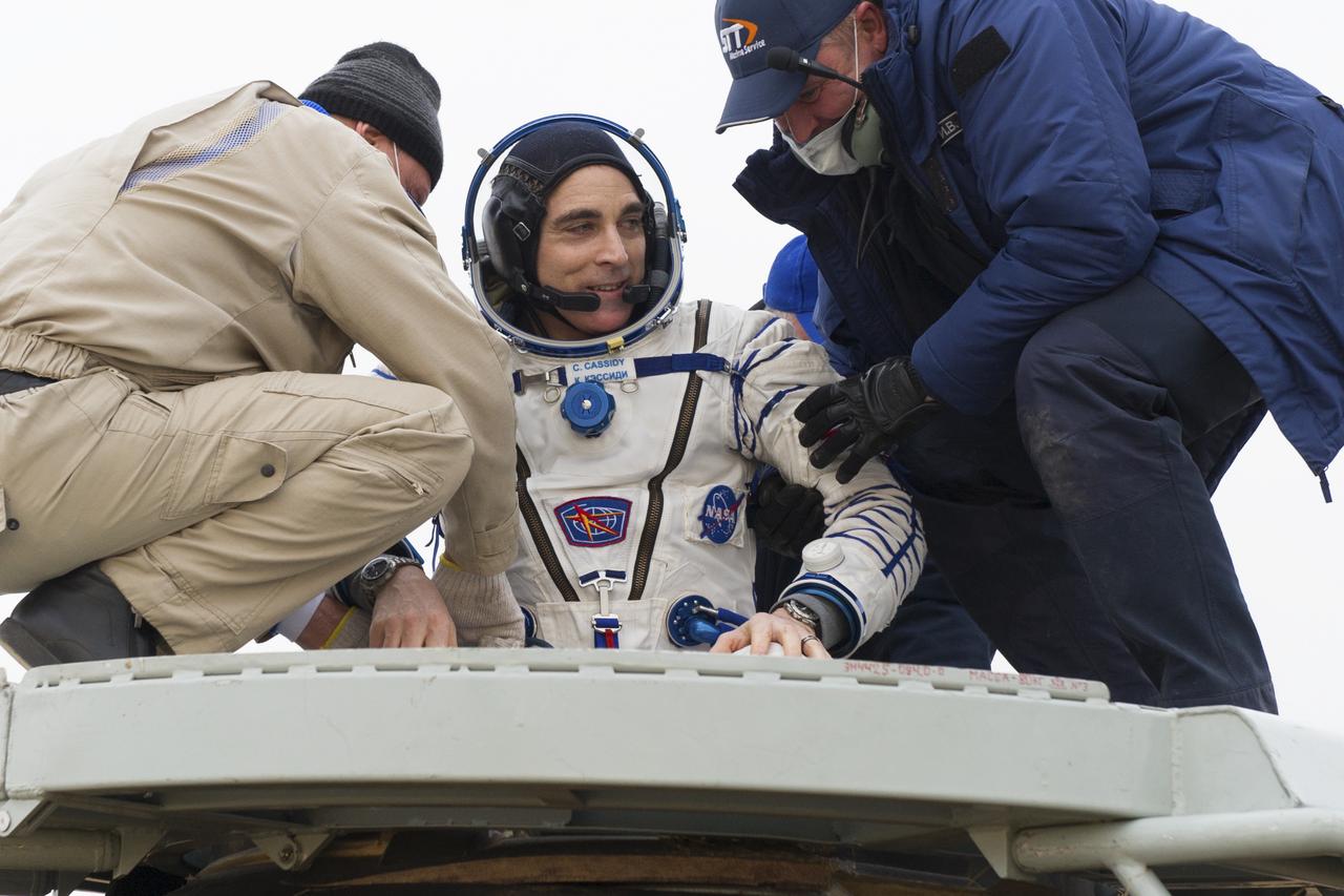 Expedition 63 NASA astronaut Chris Cassidy is helped out of the Soyuz MS-16 spacecraft just minutes after he and Roscosmos cosmonauts Anatoly Ivanishin, and Ivan Vagner, landed in a remote area near the town of Zhezkazgan, Kazakhstan on Thursday, October 22, 2020, Kazakh time (Oct. 21 Eastern time). Cassidy, Ivanishin and Vagner returned after 196 days in space having served as Expedition 62-63 crew members onboard the International Space Station. Photo Credit: (NASA/GCTC/Denis Derevtsov)