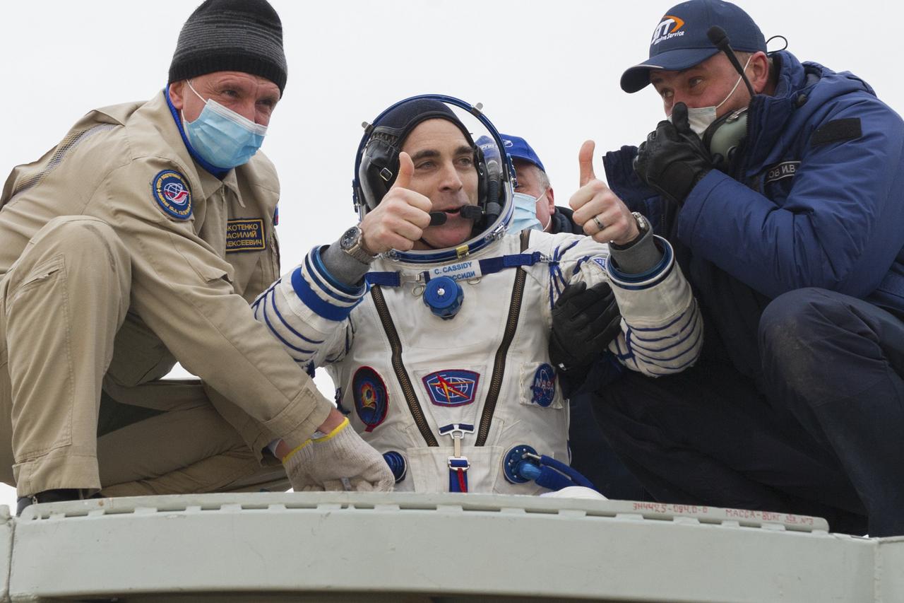 Expedition 63 NASA astronaut Chris Cassidy is helped out of the Soyuz MS-16 spacecraft just minutes after he and Roscosmos cosmonauts Anatoly Ivanishin, and Ivan Vagner, landed in a remote area near the town of Zhezkazgan, Kazakhstan on Thursday, October 22, 2020, Kazakh time (Oct. 21 Eastern time). Cassidy, Ivanishin and Vagner returned after 196 days in space having served as Expedition 62-63 crew members onboard the International Space Station. Photo Credit: (NASA/GCTC/Denis Derevtsov)