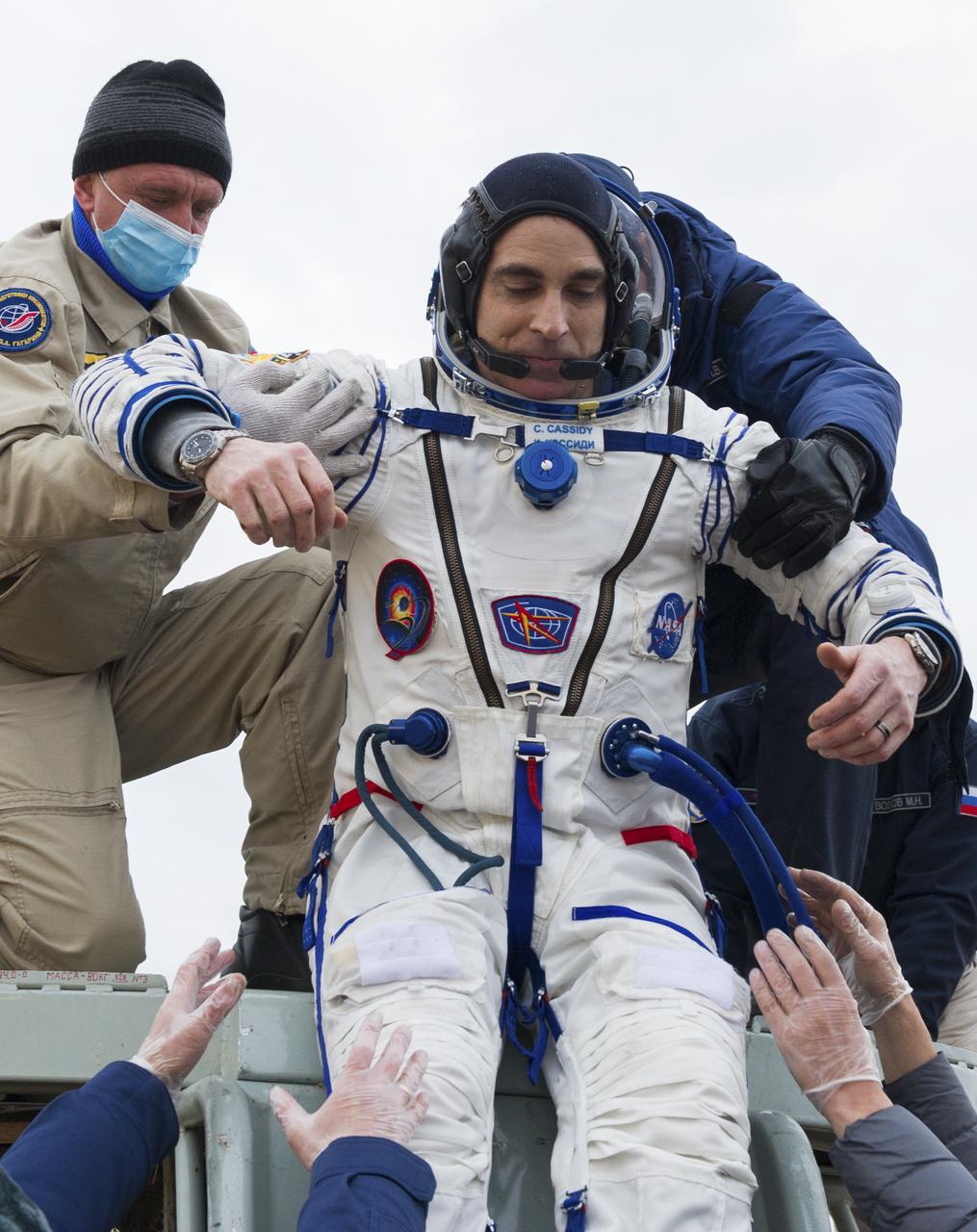 Expedition 63 NASA astronaut Chris Cassidy is helped out of the Soyuz MS-16 spacecraft just minutes after he and Roscosmos cosmonauts Anatoly Ivanishin, and Ivan Vagner, landed in a remote area near the town of Zhezkazgan, Kazakhstan on Thursday, October 22, 2020, Kazakh time (Oct. 21 Eastern time). Cassidy, Ivanishin and Vagner returned after 196 days in space having served as Expedition 62-63 crew members onboard the International Space Station. Photo Credit: (NASA/GCTC/Denis Derevtsov)