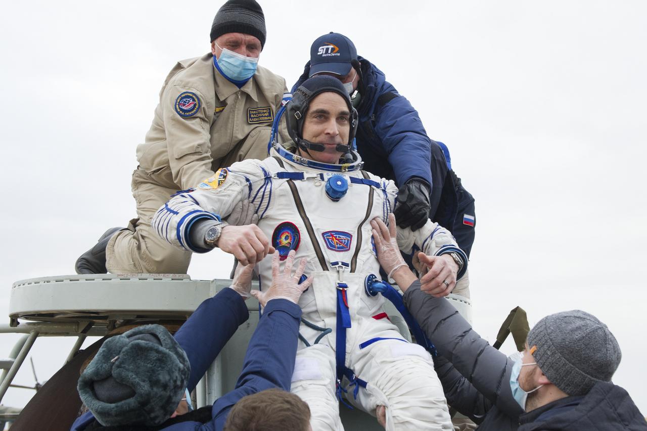 Expedition 63 NASA astronaut Chris Cassidy is helped out of the Soyuz MS-16 spacecraft just minutes after he and Roscosmos cosmonauts Anatoly Ivanishin, and Ivan Vagner, landed in a remote area near the town of Zhezkazgan, Kazakhstan on Thursday, October 22, 2020, Kazakh time (Oct. 21 Eastern time). Cassidy, Ivanishin and Vagner returned after 196 days in space having served as Expedition 62-63 crew members onboard the International Space Station. Photo Credit: (NASA/GCTC/Denis Derevtsov)
