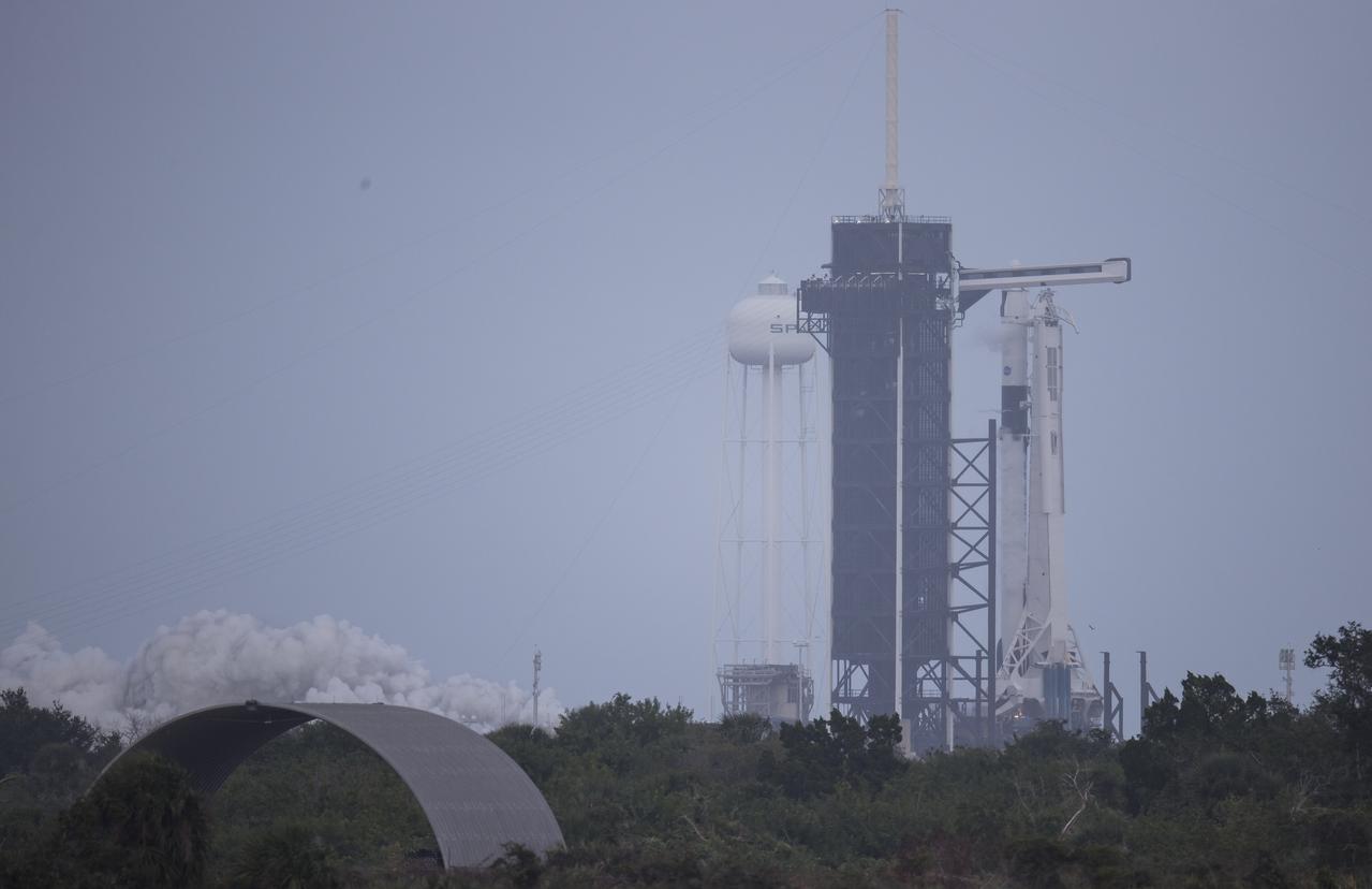 A SpaceX Falcon 9 rocket with the company's Crew Dragon spacecraft onboard is seen on the launch pad at Launch Complex 39A during a brief static fire test ahead of NASA’s SpaceX Crew-1 mission, Wednesday, Nov. 11, 2020, at NASA’s Kennedy Space Center in Florida. NASA’s SpaceX Crew-1 mission is the first operational mission of the SpaceX Crew Dragon spacecraft and Falcon 9 rocket to the International Space Station as part of the agency’s Commercial Crew Program. NASA astronauts Mike Hopkins, Victor Glover, and Shannon Walker, and astronaut Soichi Noguchi of the Japan Aerospace Exploration Agency (JAXA) are scheduled to launch at 7:49 p.m. EST on Saturday, Nov. 14, from Launch Complex 39A at the Kennedy Space Center. Photo Credit: (NASA/Joel Kowsky)