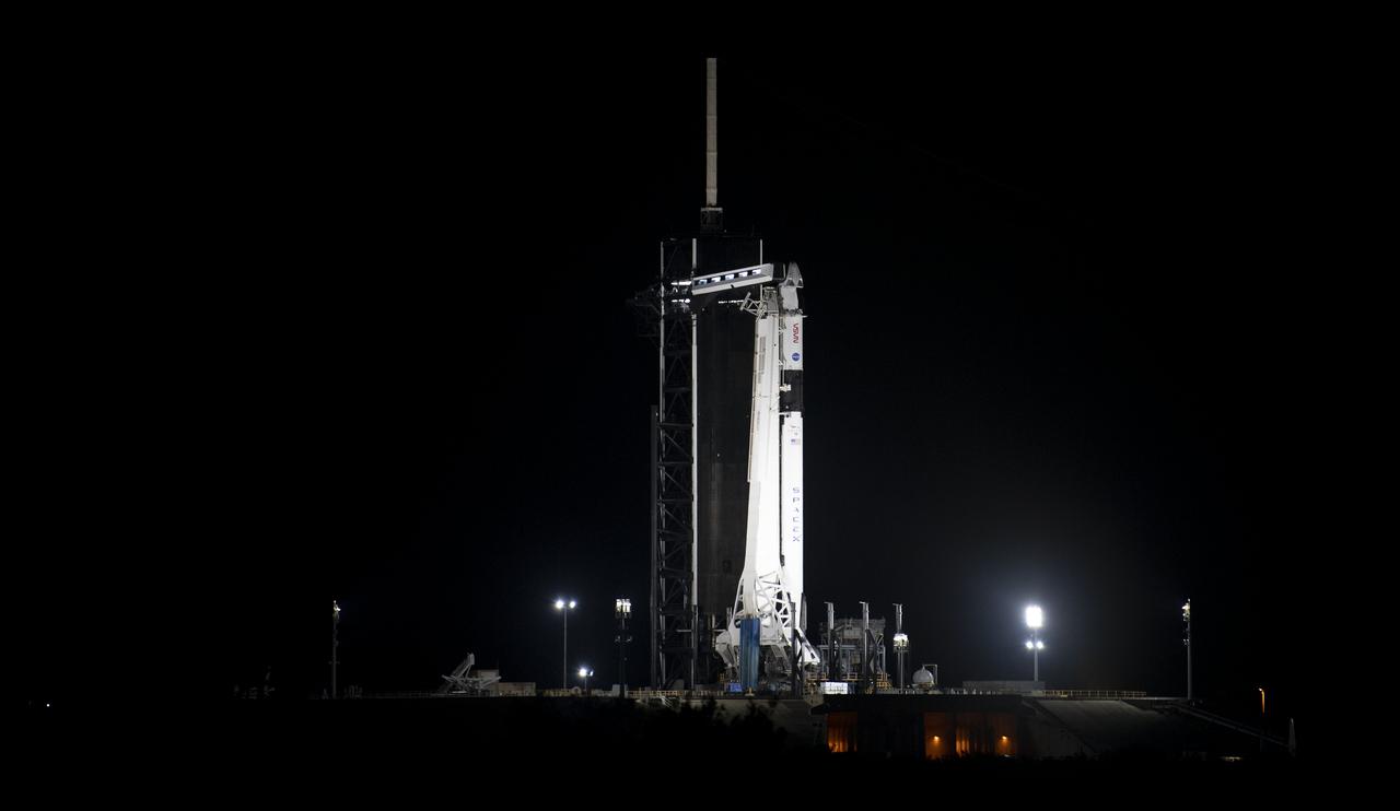 A SpaceX Falcon 9 rocket with the company's Crew Dragon spacecraft onboard is seen illuminated by spotlights on the launch pad at Launch Complex 39A as preparations continue for the Crew-1 mission, Thursday, Nov. 12, 2020, at NASA’s Kennedy Space Center in Florida. NASA’s SpaceX Crew-1 mission is the first crew rotation mission of the SpaceX Crew Dragon spacecraft and Falcon 9 rocket to the International Space Station as part of the agency’s Commercial Crew Program. NASA astronauts Mike Hopkins, Victor Glover, and Shannon Walker, and astronaut Soichi Noguchi of the Japan Aerospace Exploration Agency (JAXA) are scheduled to launch at 7:49 p.m. EST on Saturday, Nov. 14, from Launch Complex 39A at the Kennedy Space Center. Photo Credit: (NASA/Joel Kowsky)