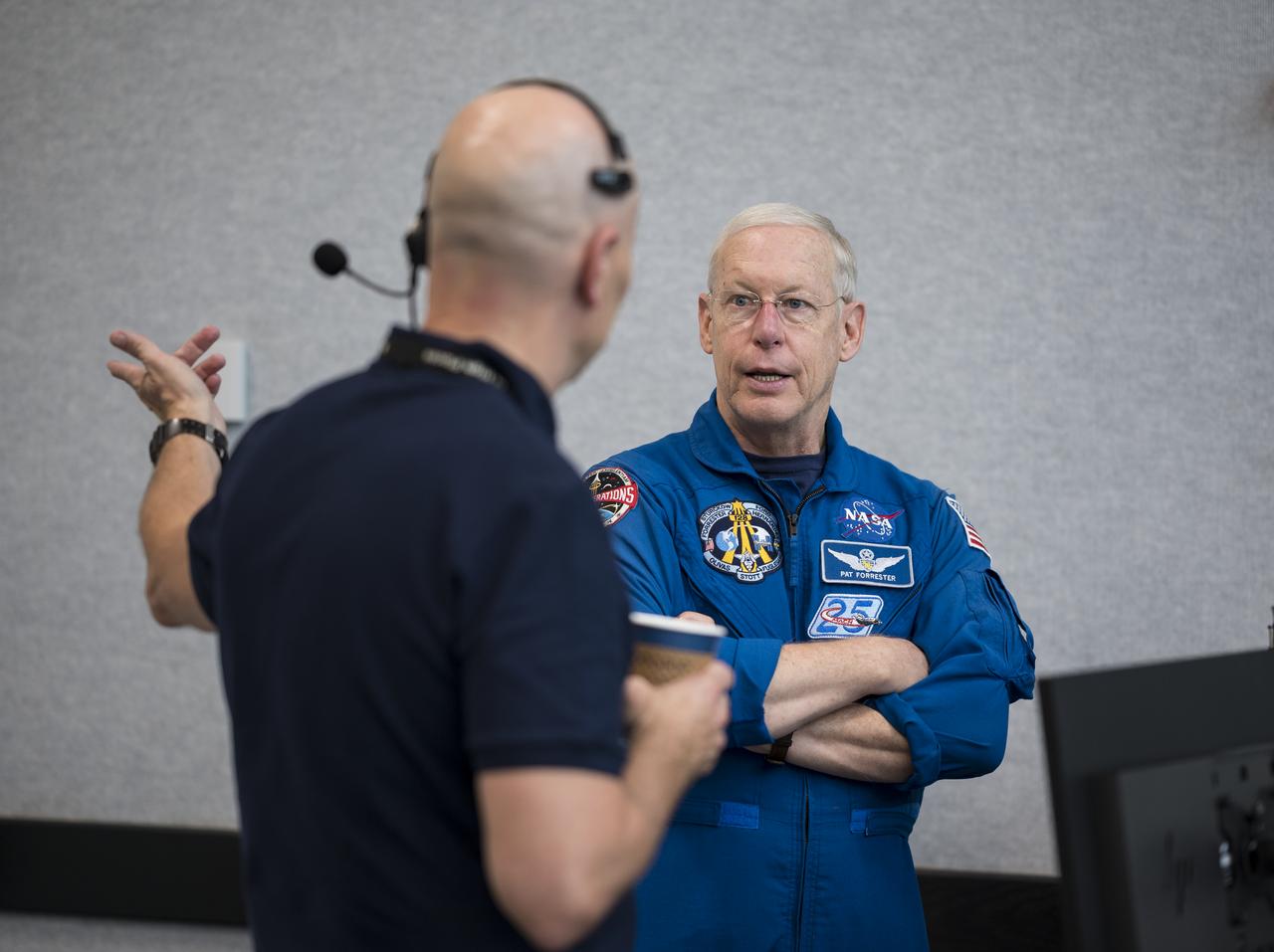 Pat Forrester, Chief of the Astronaut Office, speaks with Stephen Koerner, director of the Flight Operations Directorate at NASA’s Johnson Space Center during a dress rehearsal in preparation for the launch of a SpaceX Falcon 9 rocket carrying the company's Crew Dragon spacecraft on NASA’s SpaceX Crew-1 mission with NASA astronauts Mike Hopkins, Victor Glover, Shannon Walker, and Japan Aerospace Exploration Agency (JAXA) astronaut Soichi Noguchi onboard, Thursday, Nov. 12, 2020, in firing room four of the Launch Control Center at NASA’s Kennedy Space Center in Florida. NASA’s SpaceX Crew-1 mission is the first crew rotation mission of the SpaceX Crew Dragon spacecraft and Falcon 9 rocket to the International Space Station as part of the agency’s Commercial Crew Program. Hopkins, Glover, Walker, and Noguchi are scheduled to launch at 7:49 p.m. EST on Saturday, Nov. 14, from Launch Complex 39A at the Kennedy Space Center. Photo Credit: (NASA/Aubrey Gemignani)