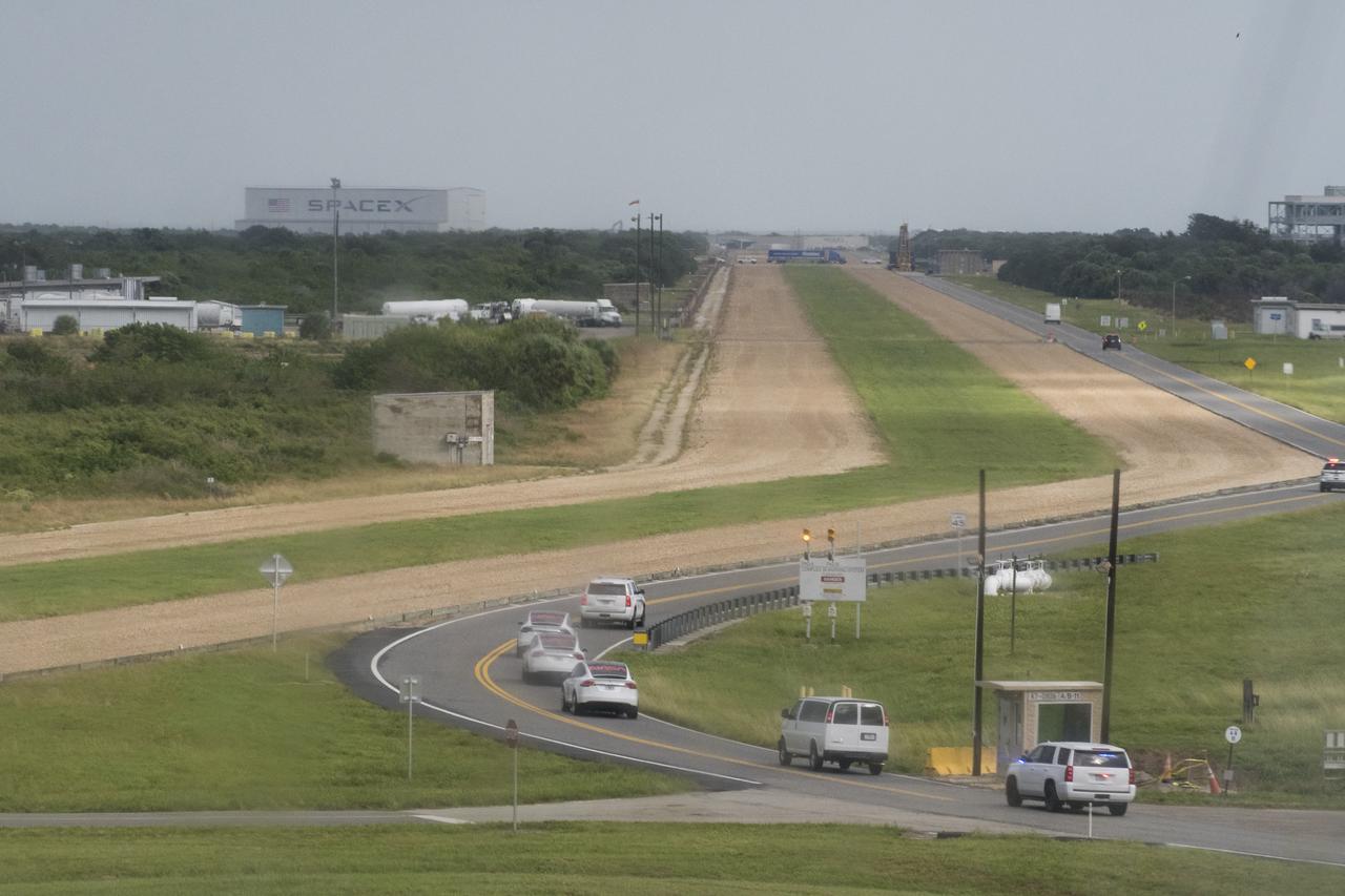 The convoy carrying NASA astronauts Mike Hopkins, Victor Glover, Shannon Walker, and Japan Aerospace Exploration Agency (JAXA) astronaut Soichi Noguchi are seen through the rain soaked windows of firing room four as it makes its way to Launch Complex 39A during a dress rehearsal in preparation for the launch of a SpaceX Falcon 9 rocket carrying the company's Crew Dragon spacecraft on NASA’s SpaceX Crew-1 mission, Thursday, Nov. 12, 2020, in the Launch Control Center at NASA’s Kennedy Space Center in Florida. NASA’s SpaceX Crew-1 mission is the first crew rotation mission of the SpaceX Crew Dragon spacecraft and Falcon 9 rocket to the International Space Station as part of the agency’s Commercial Crew Program. Hopkins, Glover, Walker, and Noguchi are scheduled to launch at 7:49 p.m. EST on Saturday, Nov. 14, from Launch Complex 39A at the Kennedy Space Center. Photo Credit: (NASA/Aubrey Gemignani)