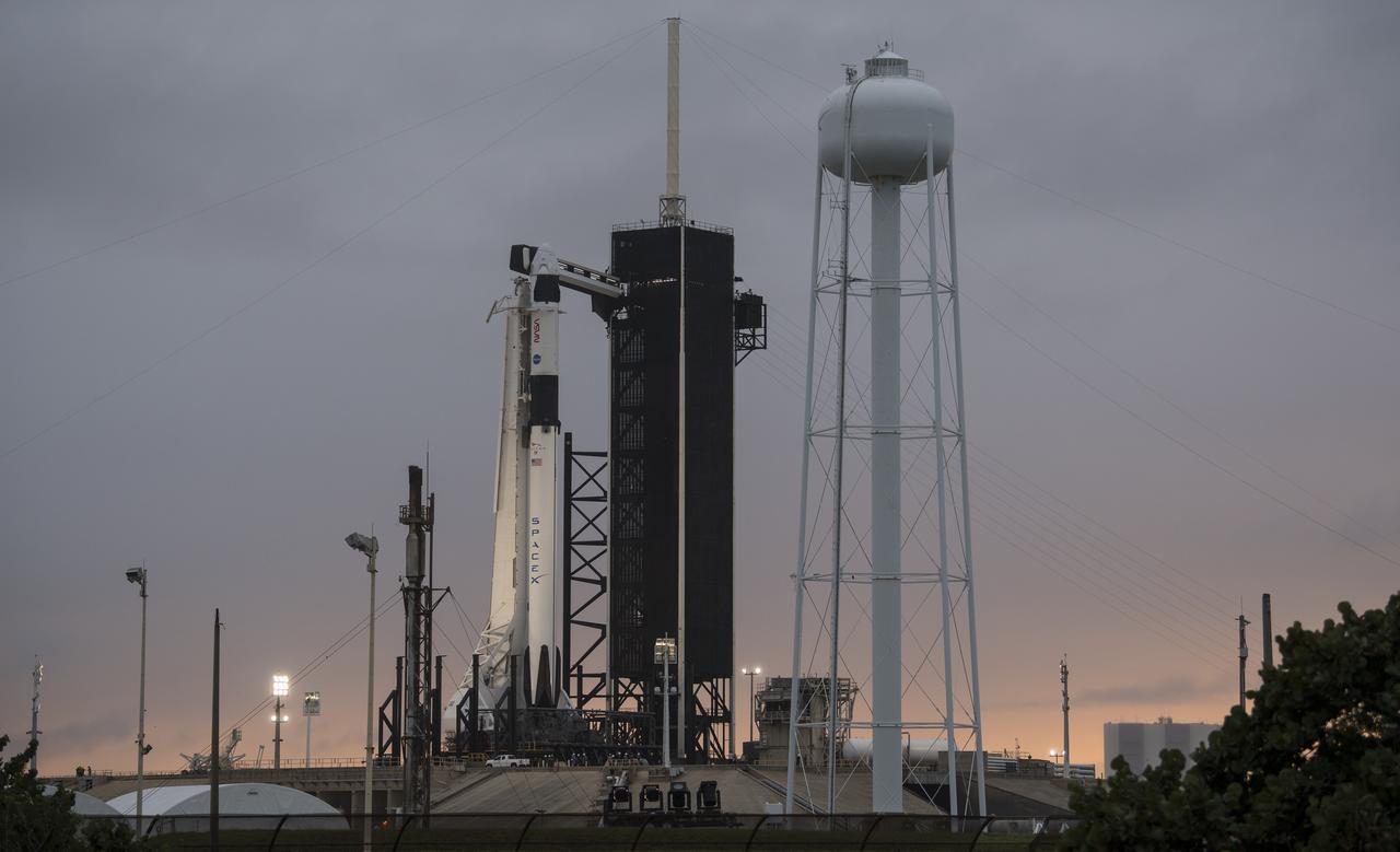 A SpaceX Falcon 9 rocket with the company's Crew Dragon spacecraft onboard is seen on the launch pad at Launch Complex 39A at sunset as preparations continue for the Crew-1 mission, Saturday, Nov. 14, 2020, at NASA’s Kennedy Space Center in Florida. NASA’s SpaceX Crew-1 mission is the first crew rotation mission of the SpaceX Crew Dragon spacecraft and Falcon 9 rocket to the International Space Station as part of the agency’s Commercial Crew Program. NASA astronauts Mike Hopkins, Victor Glover, and Shannon Walker, and astronaut Soichi Noguchi of the Japan Aerospace Exploration Agency (JAXA) are scheduled to launch at 7:27 p.m. EST on Sunday, Nov. 15, from Launch Complex 39A at the Kennedy Space Center. Photo Credit: (NASA/Joel Kowsky)