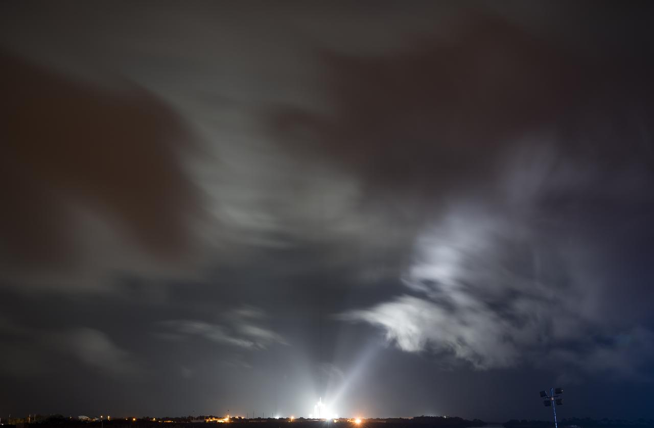 A SpaceX Falcon 9 rocket with the company's Crew Dragon spacecraft onboard is seen, in this thirty second exposure, illuminated by spotlights on the launch pad at Launch Complex 39A as preparations continue for the Crew-1 mission, Saturday, Nov. 14, 2020, at NASA’s Kennedy Space Center in Florida. NASA’s SpaceX Crew-1 mission is the first crew rotation mission of the SpaceX Crew Dragon spacecraft and Falcon 9 rocket to the International Space Station as part of the agency’s Commercial Crew Program. NASA astronauts Mike Hopkins, Victor Glover, and Shannon Walker, and astronaut Soichi Noguchi of the Japan Aerospace Exploration Agency (JAXA) are scheduled to launch at 7:27 p.m. EST on Sunday, Nov. 15, from Launch Complex 39A at the Kennedy Space Center. Photo Credit: (NASA/Joel Kowsky)
