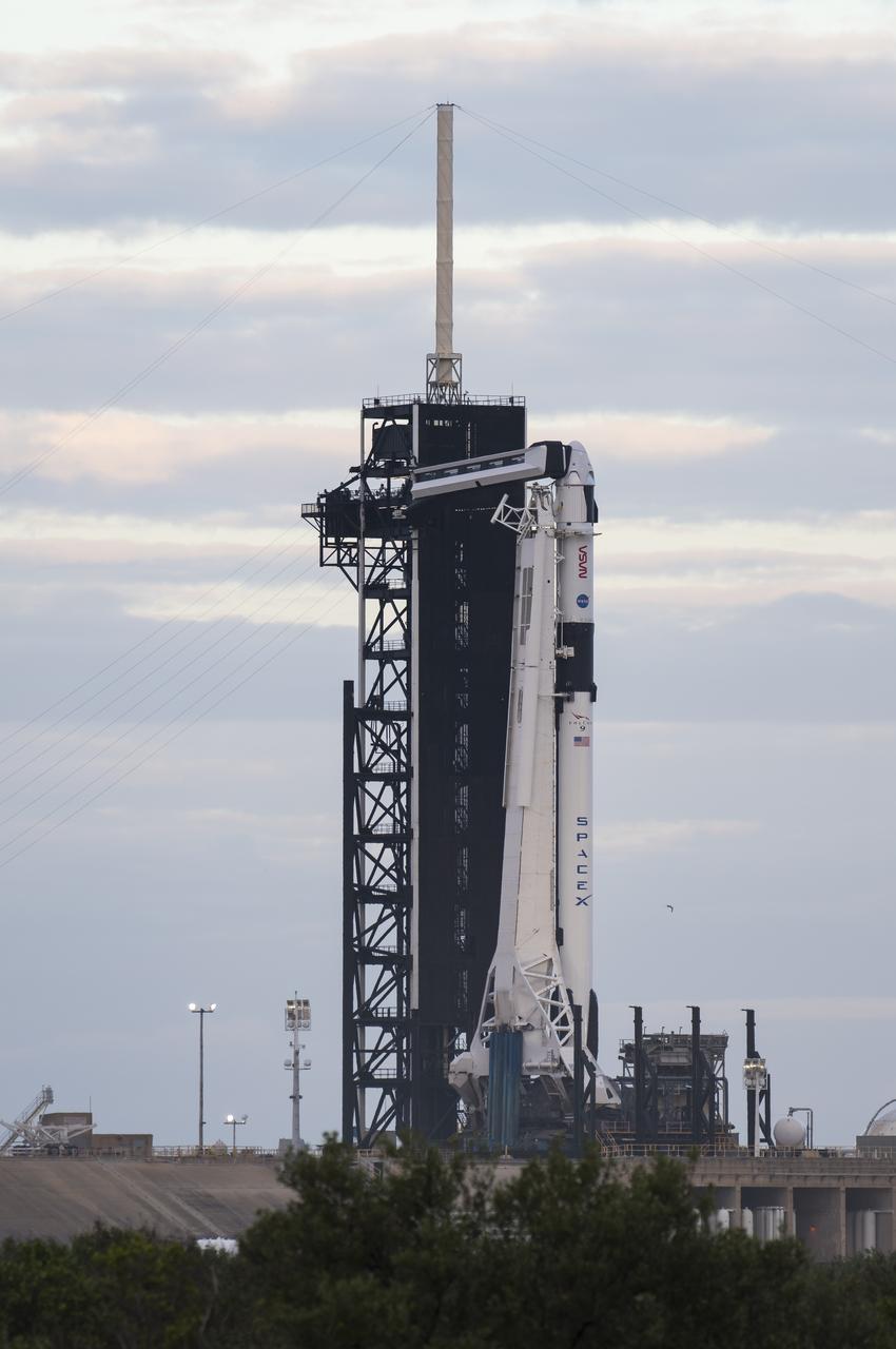 A SpaceX Falcon 9 rocket with the company's Crew Dragon spacecraft onboard is seen on the launch pad at sunrise at Launch Complex 39A as preparations continue for the Crew-1 mission, Sunday, Nov. 15, 2020, at NASA’s Kennedy Space Center in Florida. NASA’s SpaceX Crew-1 mission is the first crew rotational mission of the SpaceX Crew Dragon spacecraft and Falcon 9 rocket to the International Space Station as part of the agency’s Commercial Crew Program. NASA astronauts Mike Hopkins, Victor Glover, and Shannon Walker, and astronaut Soichi Noguchi of the Japan Aerospace Exploration Agency (JAXA) are scheduled to launch at 7:27 p.m. EST on Sunday, Nov. 15, from Launch Complex 39A at the Kennedy Space Center. Photo Credit: (NASA/Aubrey Gemignani)