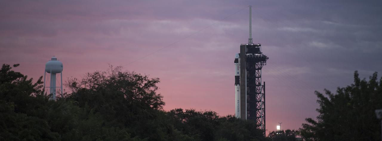 A SpaceX Falcon 9 rocket with the company's Crew Dragon spacecraft onboard is seen at sunrise on the launch pad at Launch Complex 39A as preparations continue for the Crew-1 mission, Sunday, Nov. 15, 2020, at NASA’s Kennedy Space Center in Florida. NASA’s SpaceX Crew-1 mission is the first crew rotation mission of the SpaceX Crew Dragon spacecraft and Falcon 9 rocket to the International Space Station as part of the agency’s Commercial Crew Program. NASA astronauts Mike Hopkins, Victor Glover, and Shannon Walker, and astronaut Soichi Noguchi of the Japan Aerospace Exploration Agency (JAXA) are scheduled to launch at 7:27 p.m. EST on Sunday, Nov. 15, from Launch Complex 39A at the Kennedy Space Center. Photo Credit: (NASA/Joel Kowsky)