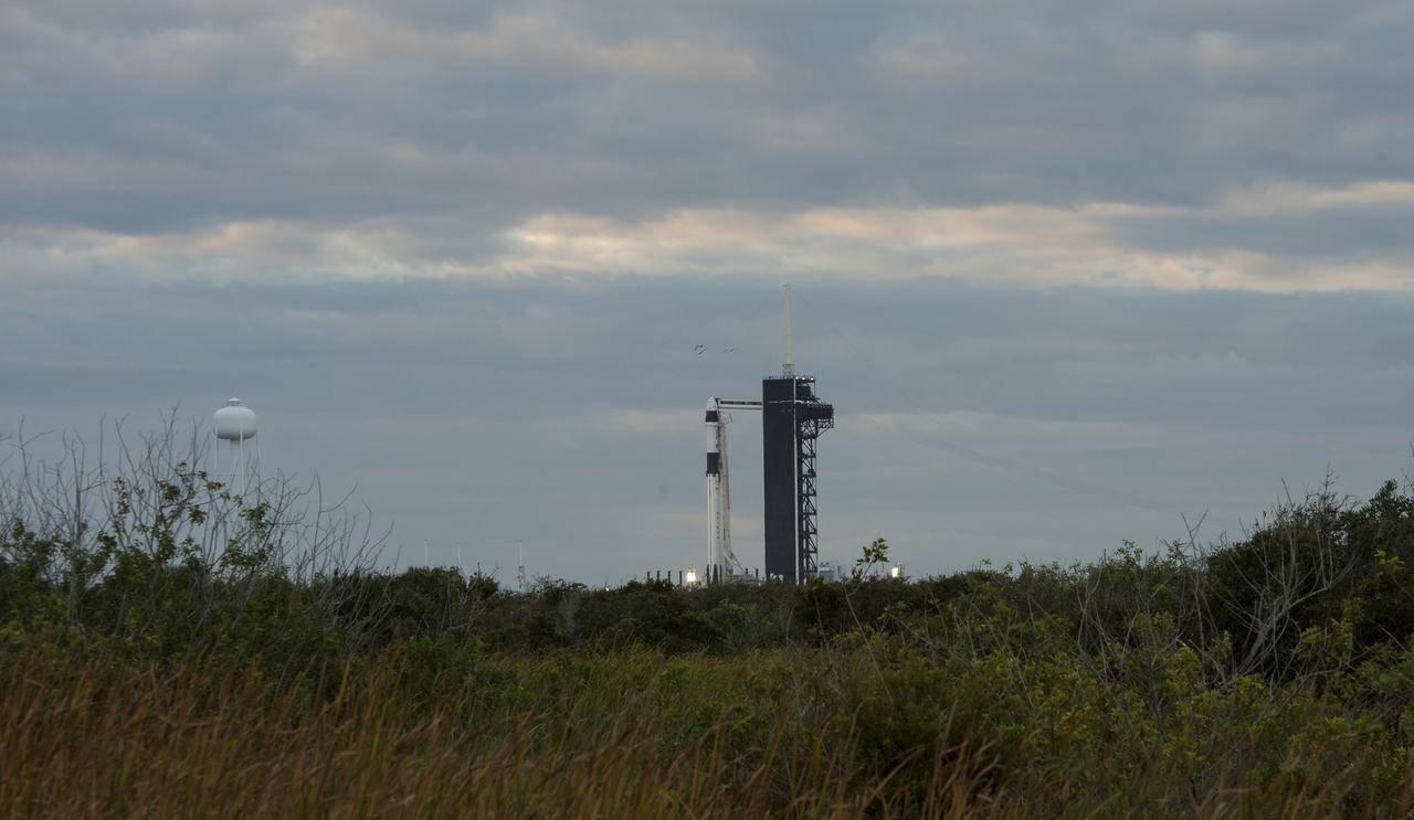 A SpaceX Falcon 9 rocket with the company's Crew Dragon spacecraft onboard is seen on the launch pad at Launch Complex 39A as preparations continue for the Crew-1 mission, Sunday, Nov. 15, 2020, at NASA’s Kennedy Space Center in Florida. NASA’s SpaceX Crew-1 mission is the first crew rotation mission of the SpaceX Crew Dragon spacecraft and Falcon 9 rocket to the International Space Station as part of the agency’s Commercial Crew Program. NASA astronauts Mike Hopkins, Victor Glover, and Shannon Walker, and astronaut Soichi Noguchi of the Japan Aerospace Exploration Agency (JAXA) are scheduled to launch at 7:27 p.m. EST on Sunday, Nov. 15, from Launch Complex 39A at the Kennedy Space Center. Photo Credit: (NASA/Joel Kowsky)